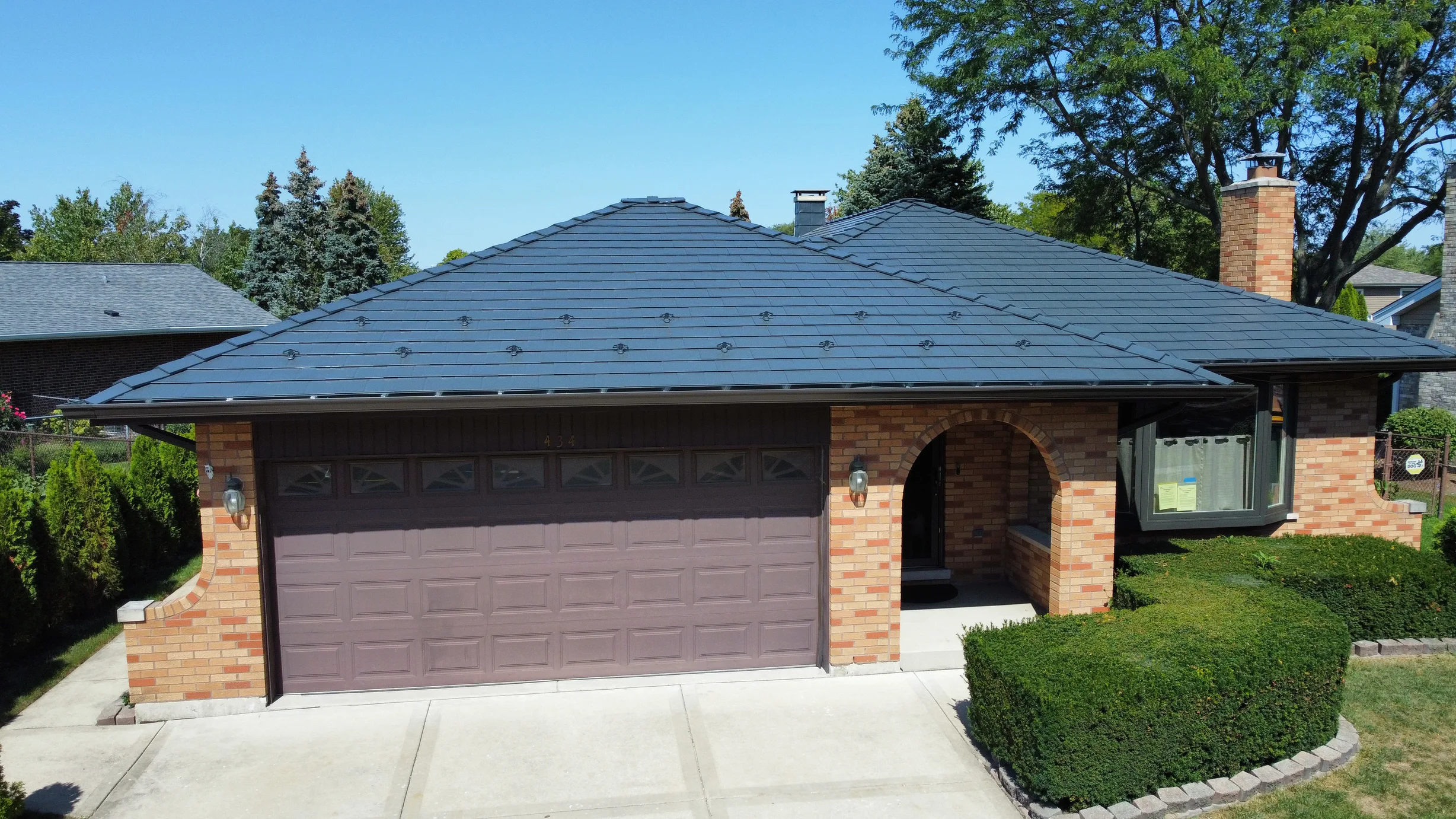 Deep Charcoal Interlock Slate aluminum roof on a Deep Charcoal metal roof on a brick ranch in a suburban, Westmont, Illinois