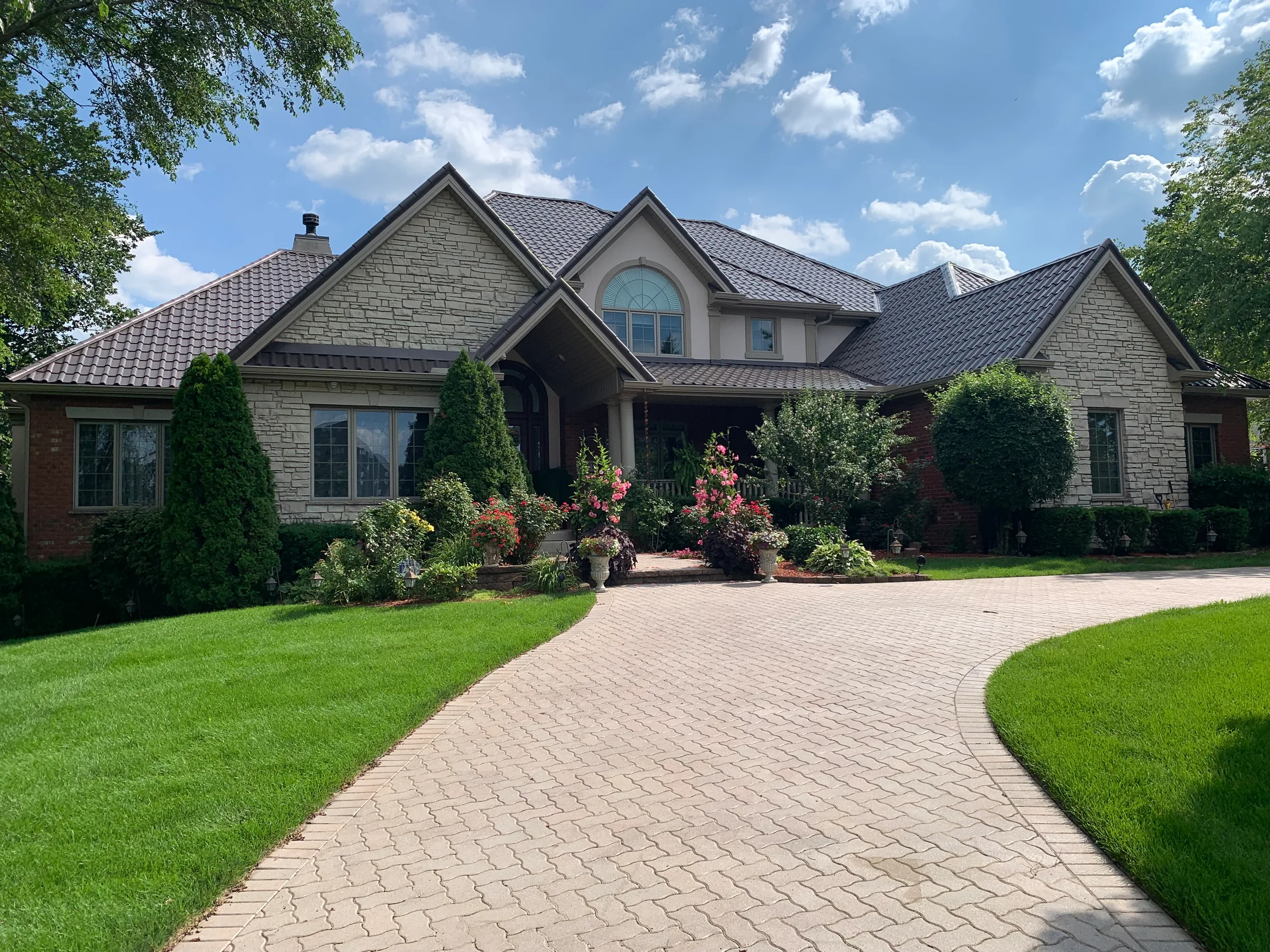 Tudor Brown Interlock Tile aluminum roof on a Tudor Brown metal roof on a colonial style home in a, Lemont, Illinois