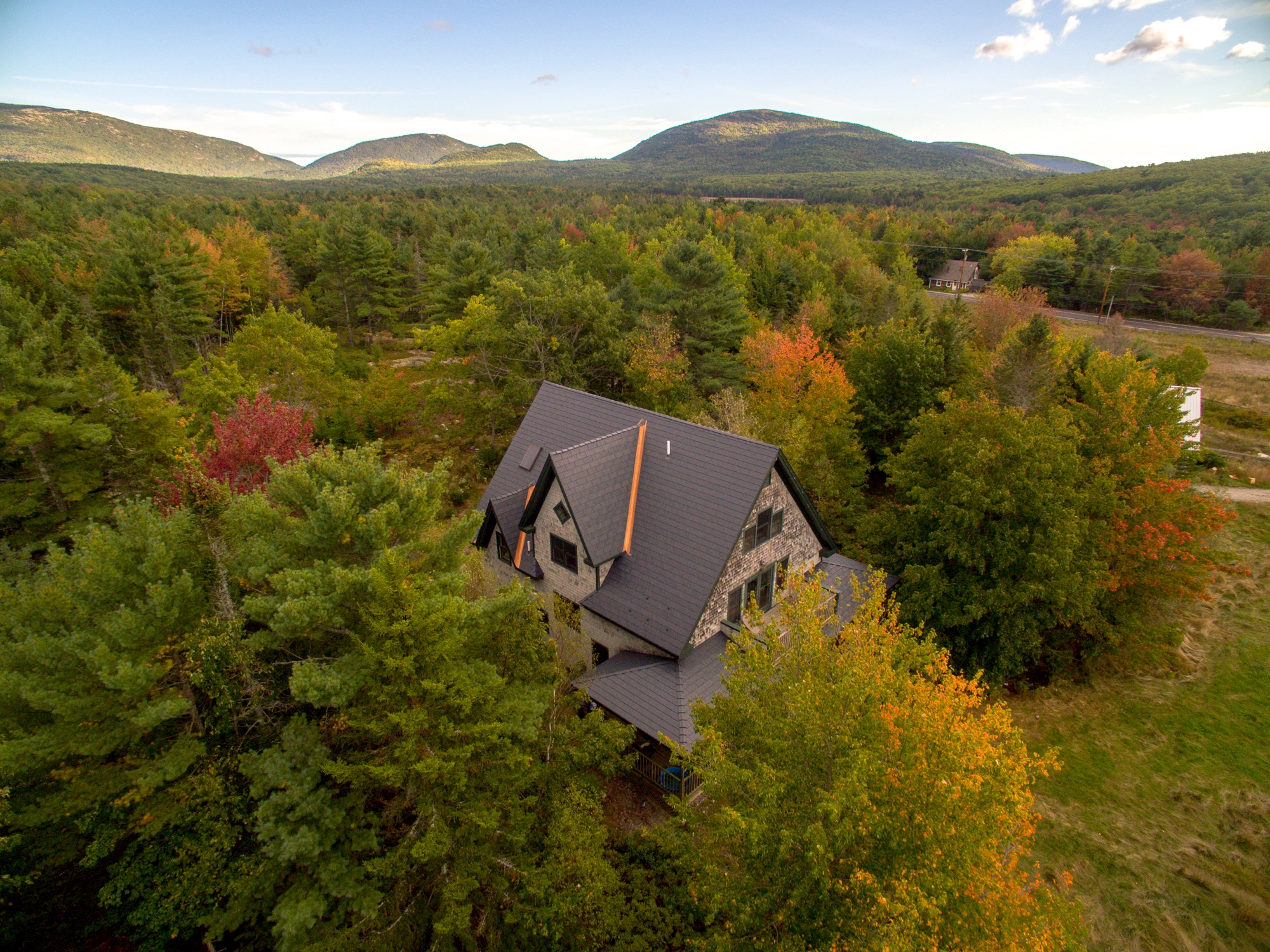 Deep Charcoal Interlock Cedar Shingle aluminum roof on a deep charcoal metal roof on a modern home in a forested, Bar Harbor, Maine