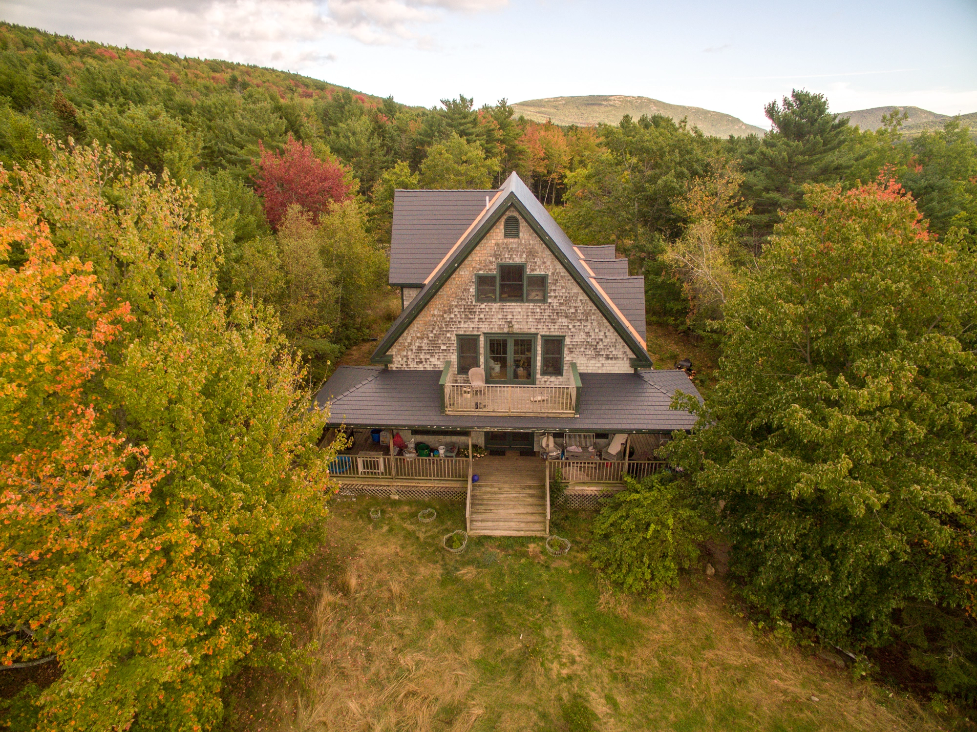 Deep Charcoal Interlock Cedar Shingle aluminum roof on a brown A-frame home in the woods, Bar Harbor, Maine