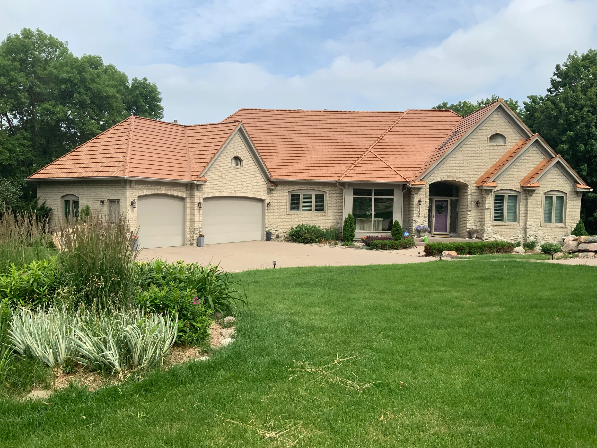 Aged Copper Interlock Shake aluminum roof on a ranch home with an aged copper metal roof in a forested, Eden Prairie, Minnesota