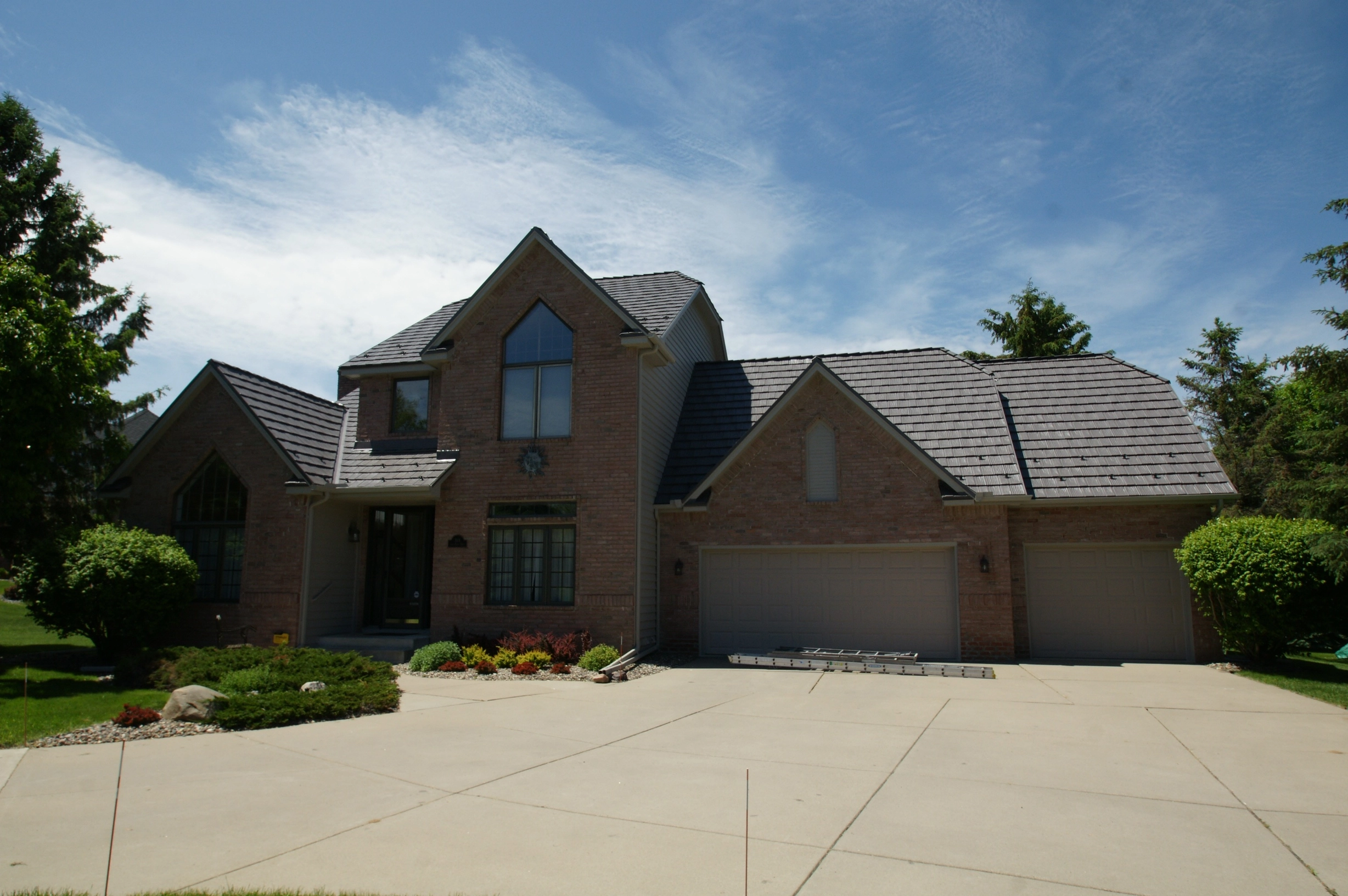 Weathered Interlock Shake aluminum roof on a tan brick home with a metal roof in a suburban setting, Mendota Heights, Minnesota