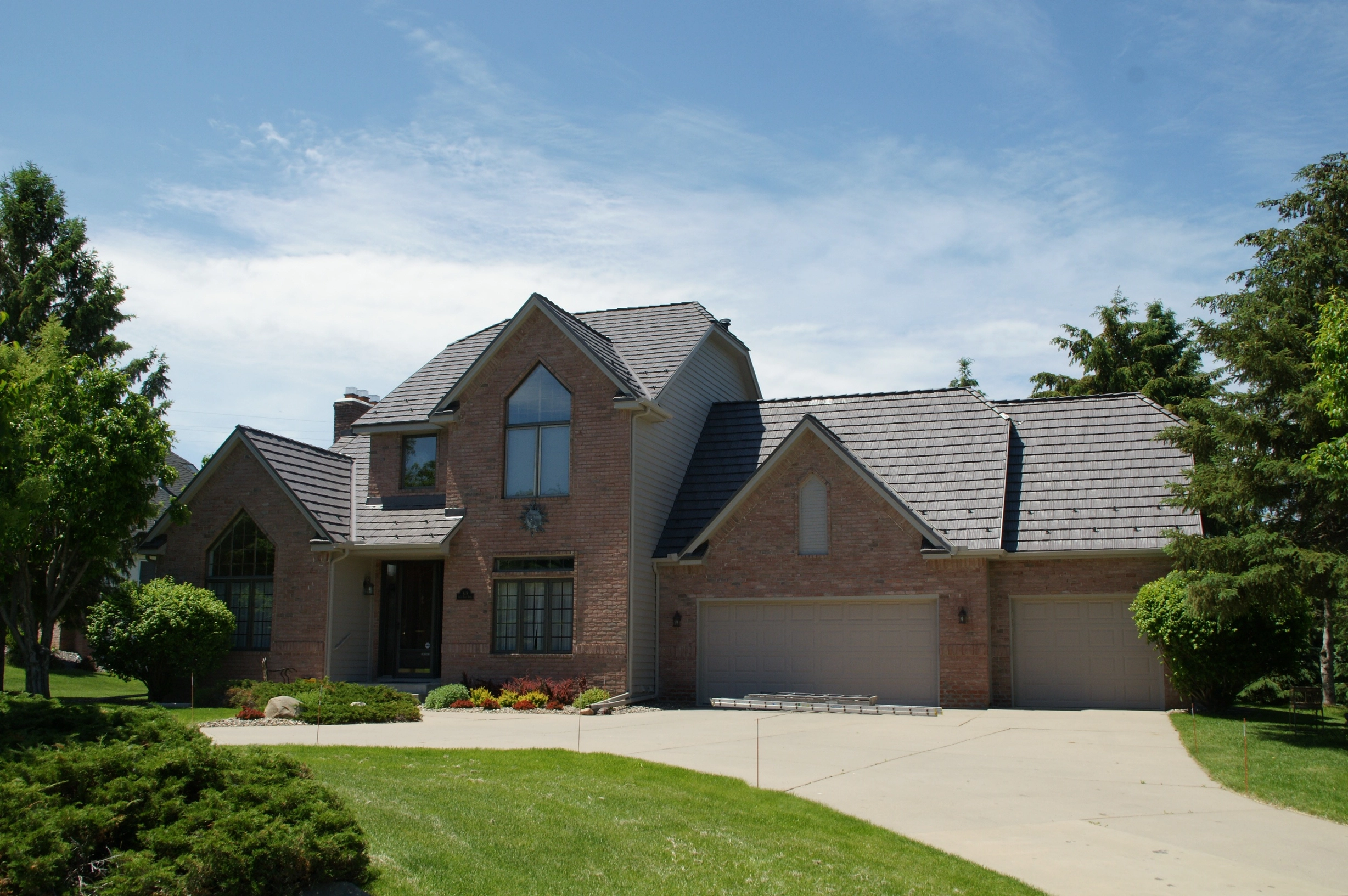 Weathered Interlock Shake aluminum roof on a two-storey home with dormers in a lush green suburban, Mendota Heights, Minnesota