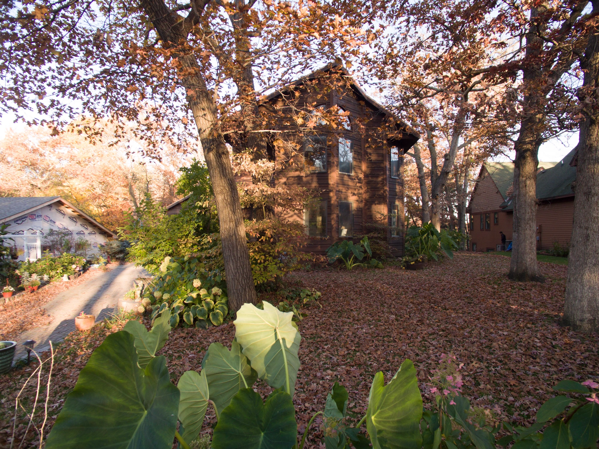 Aged Copper Interlock Shake aluminum roof on a red ranch home with a dark roof in a wooded suburban, Bloomington, Minnesota