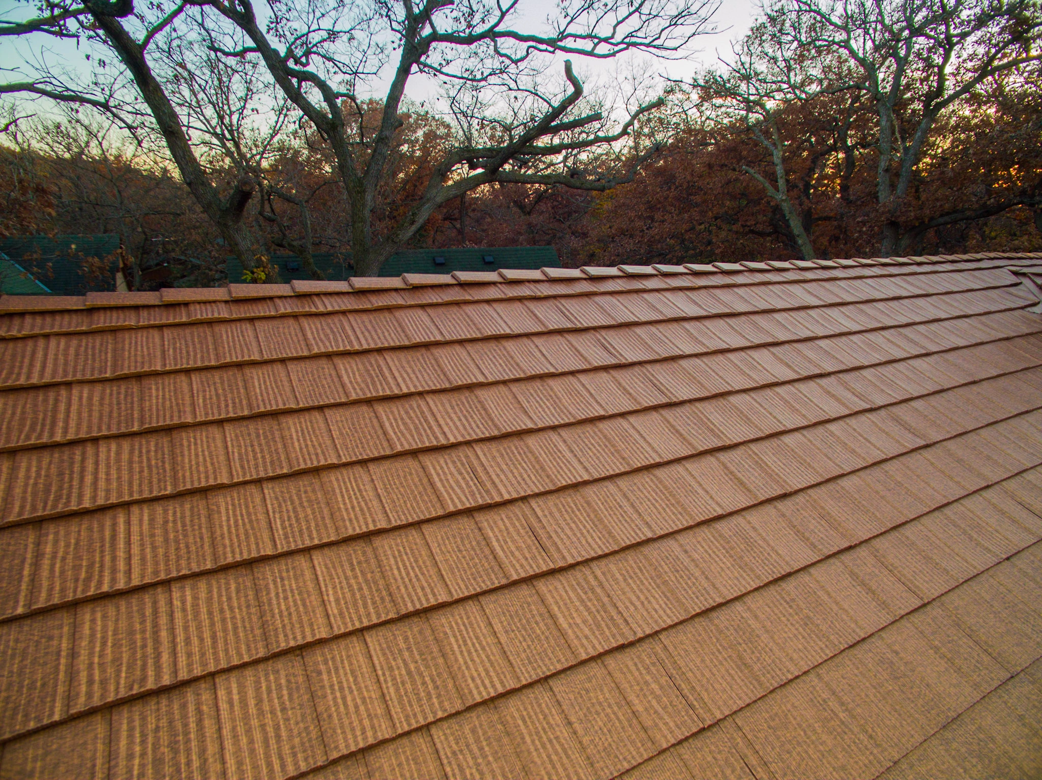 Aged Copper Interlock Shake aluminum roof on a brown single-family modern home with dormers in a, Bloomington, Minnesota