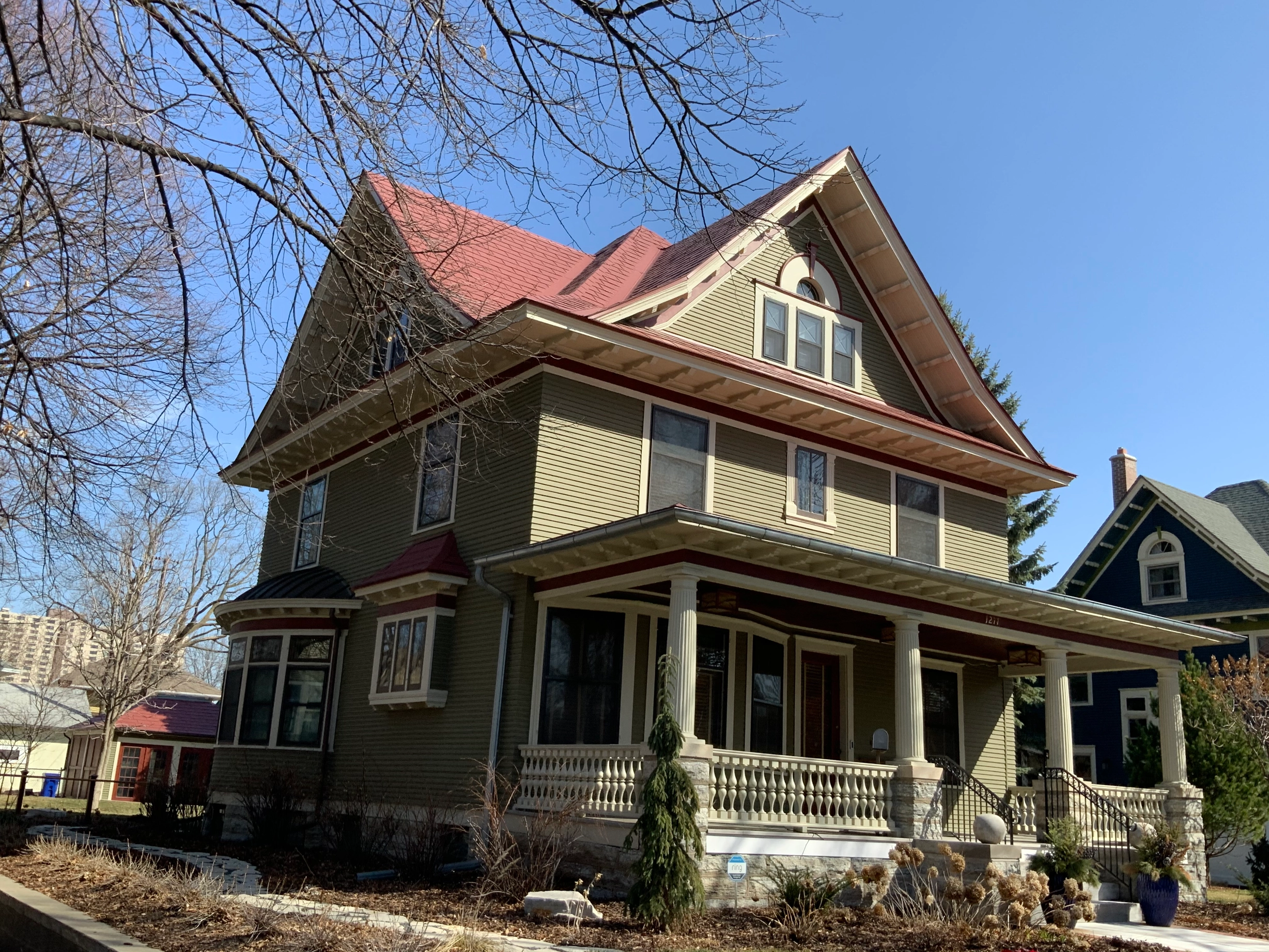 Tile Red Interlock Slate aluminum roof on a two-storey house with a red metal roof in a suburban, St. Paul, Minnesota