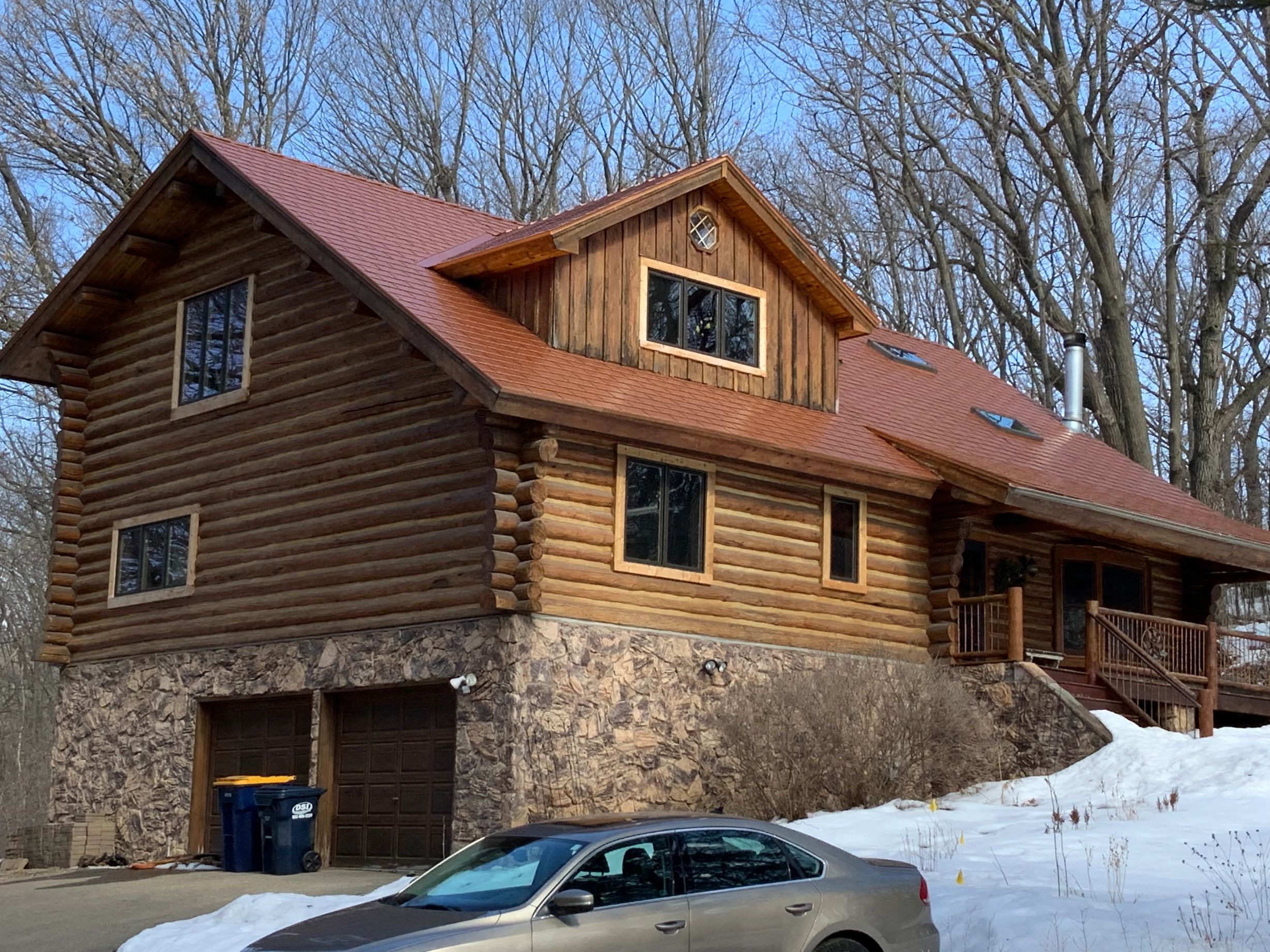 Copper Penny Interlock Cedar Shingle aluminum roof on a log cabin with a copper penny metal roof in a wooded area, Lakeville, Minnesota
