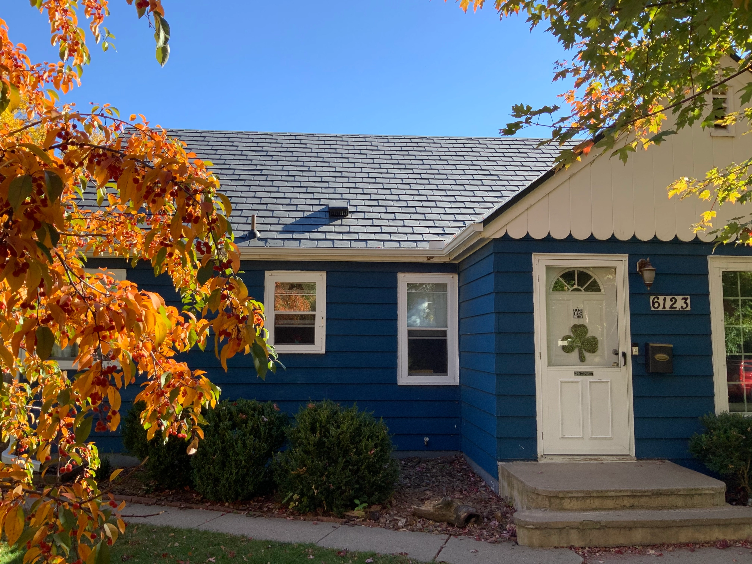 Deep Charcoal Interlock Slate aluminum roof on a Deep Charcoal two-storey home with dormers among tall, Minneapolis, Minnesota