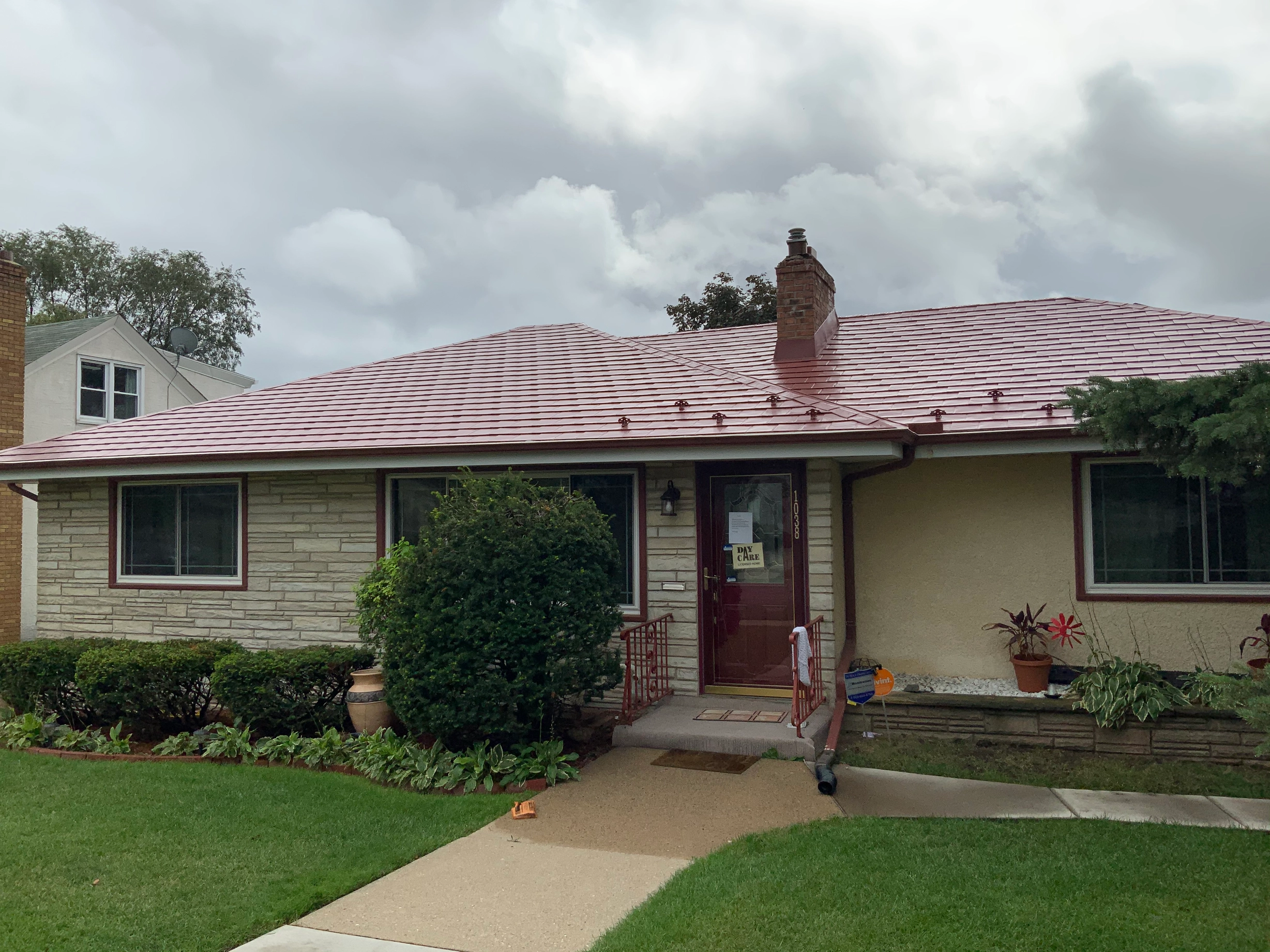 Tile Red Interlock Slate aluminum roof on a cream two-storey home with dormers in an urban/suburban, St. Paul, Minnesota