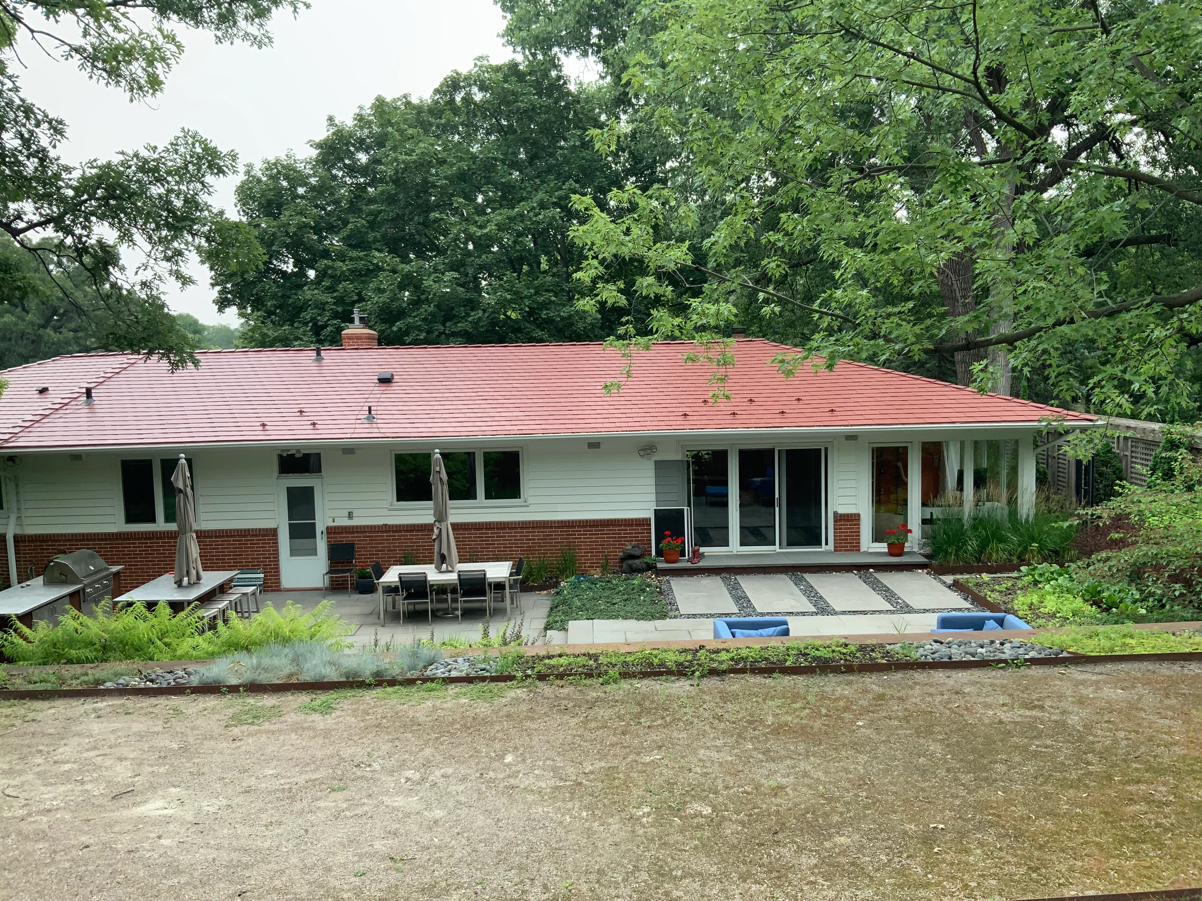 Tile Red Interlock Slate aluminum roof on a red roofed ranch style home surrounded by trees, Edina, Minnesota