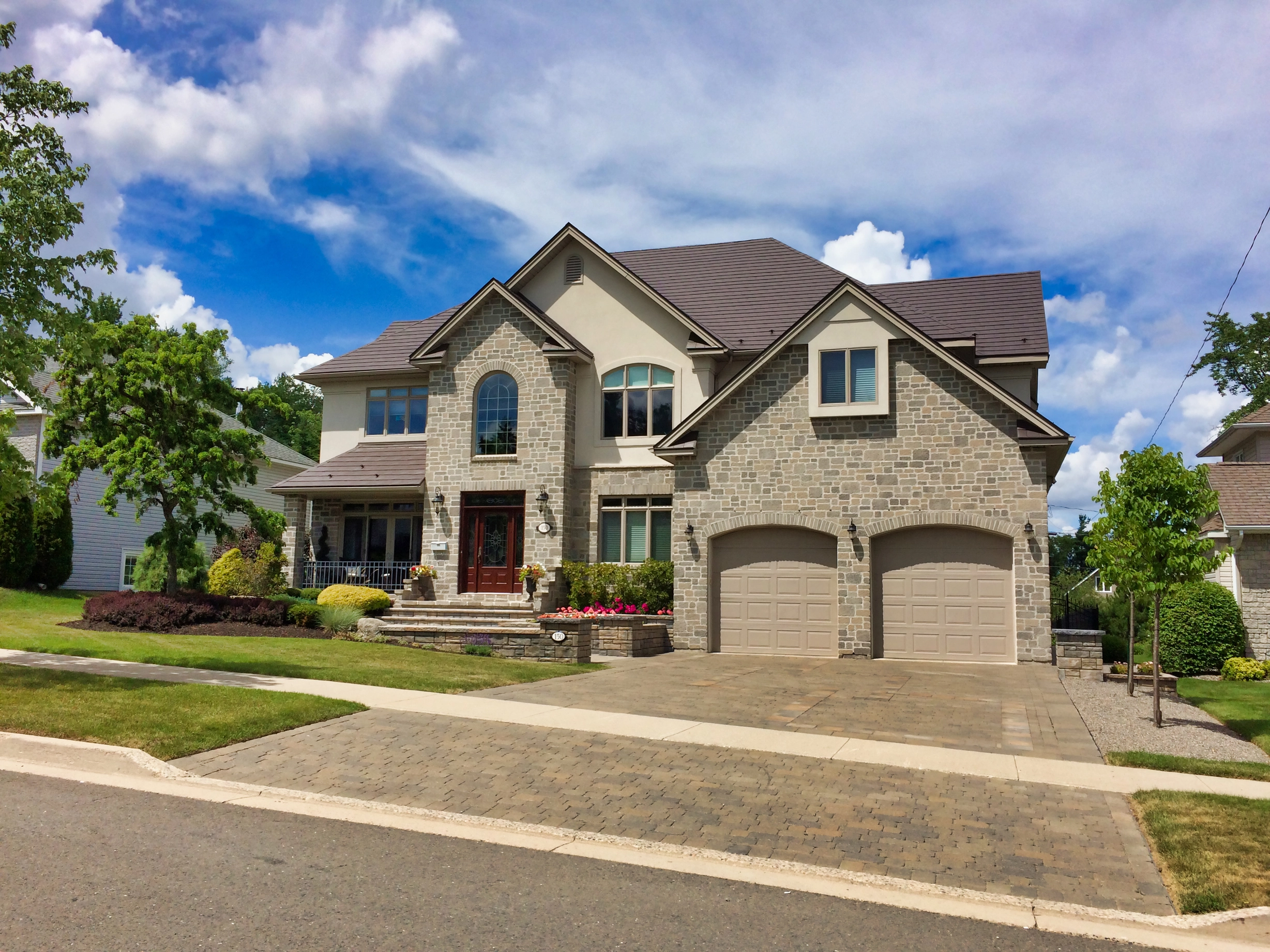 Tudor Brown Interlock Slate aluminum roof on a Tudor-style house with a Tudor Brown metal roof in a, Fredericton, New Brunswick