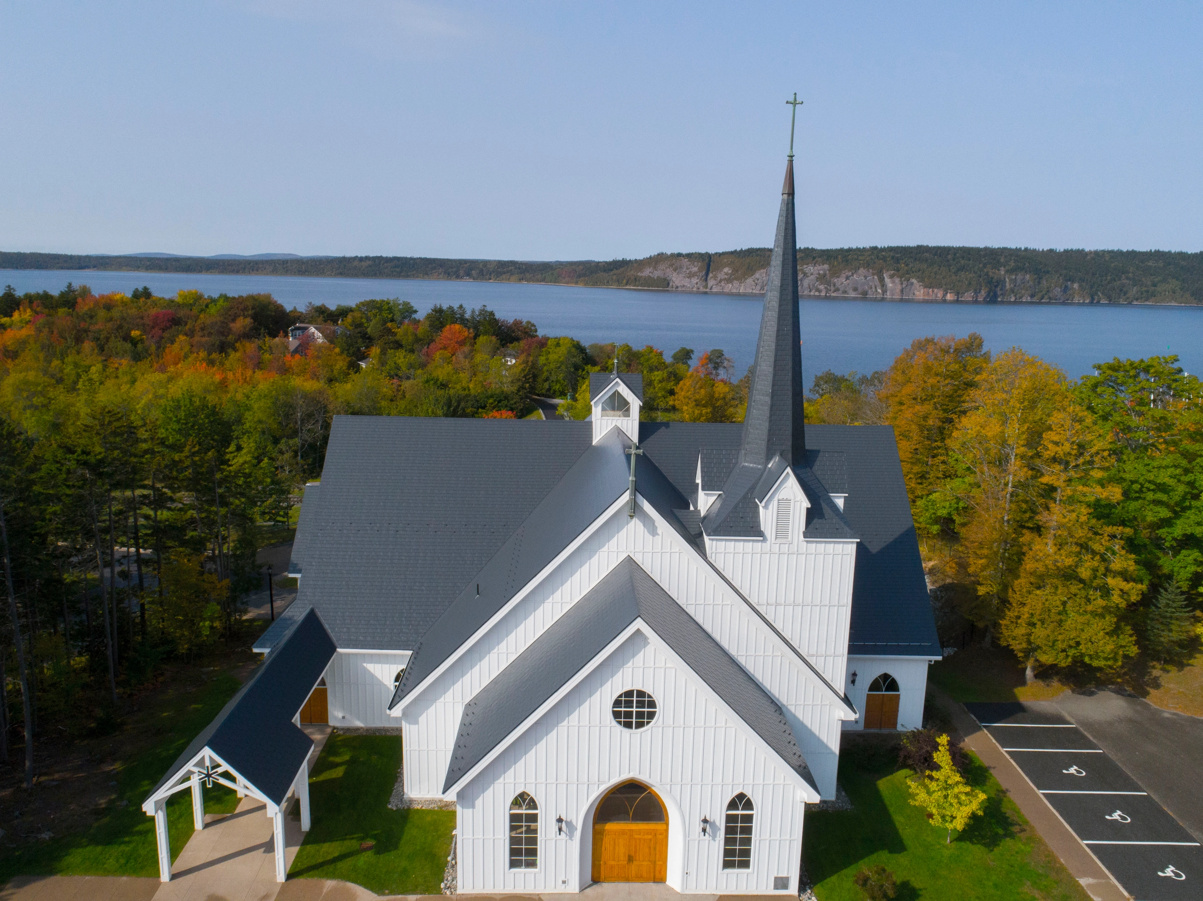 Deep Charcoal Interlock Slate aluminum roof on a white church with a slate metal roof overlooking a body, Rothesay, New Brunswick