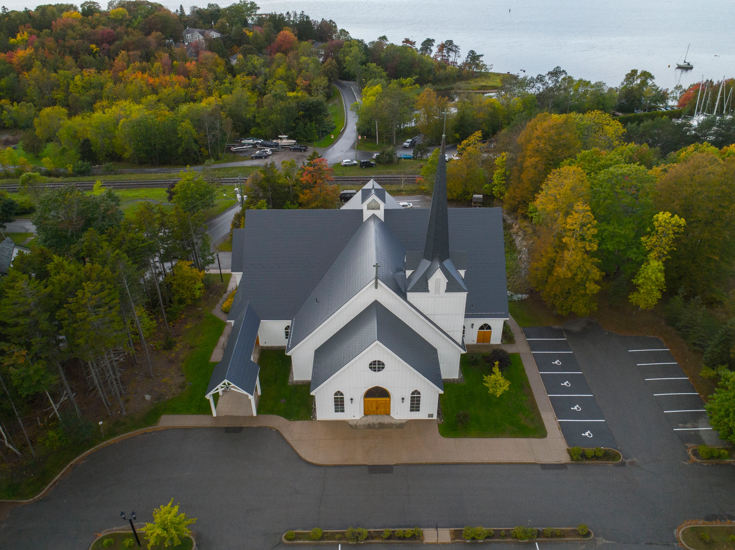 Deep Charcoal Interlock Slate aluminum roof on a white church with a metal roof in a forested area, Rothesay, New Brunswick