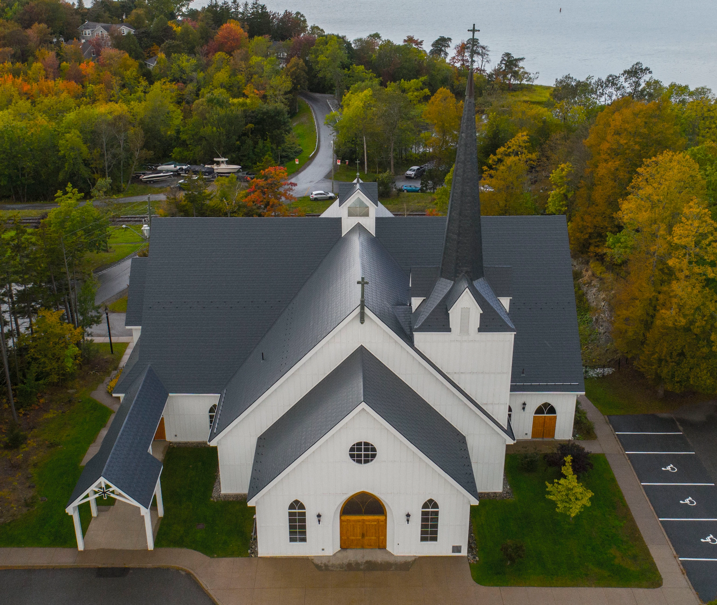 Deep Charcoal Interlock Slate aluminum roof on a white church with a grey metal roof among autumn trees, Rothesay, New Brunswick