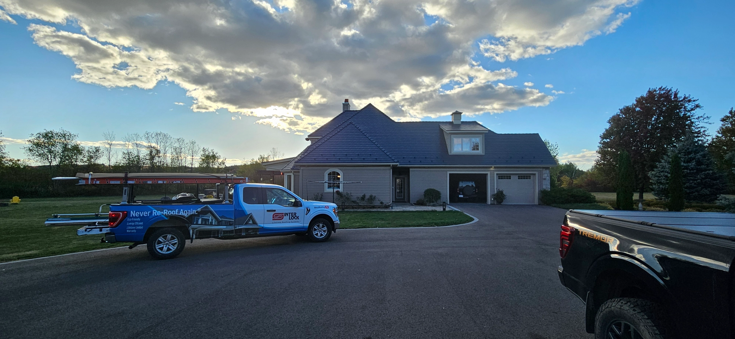 Deep Charcoal Interlock Slate aluminum roof on a two-storey ranch home with dormers and a garage, Sussex, New Brunswick