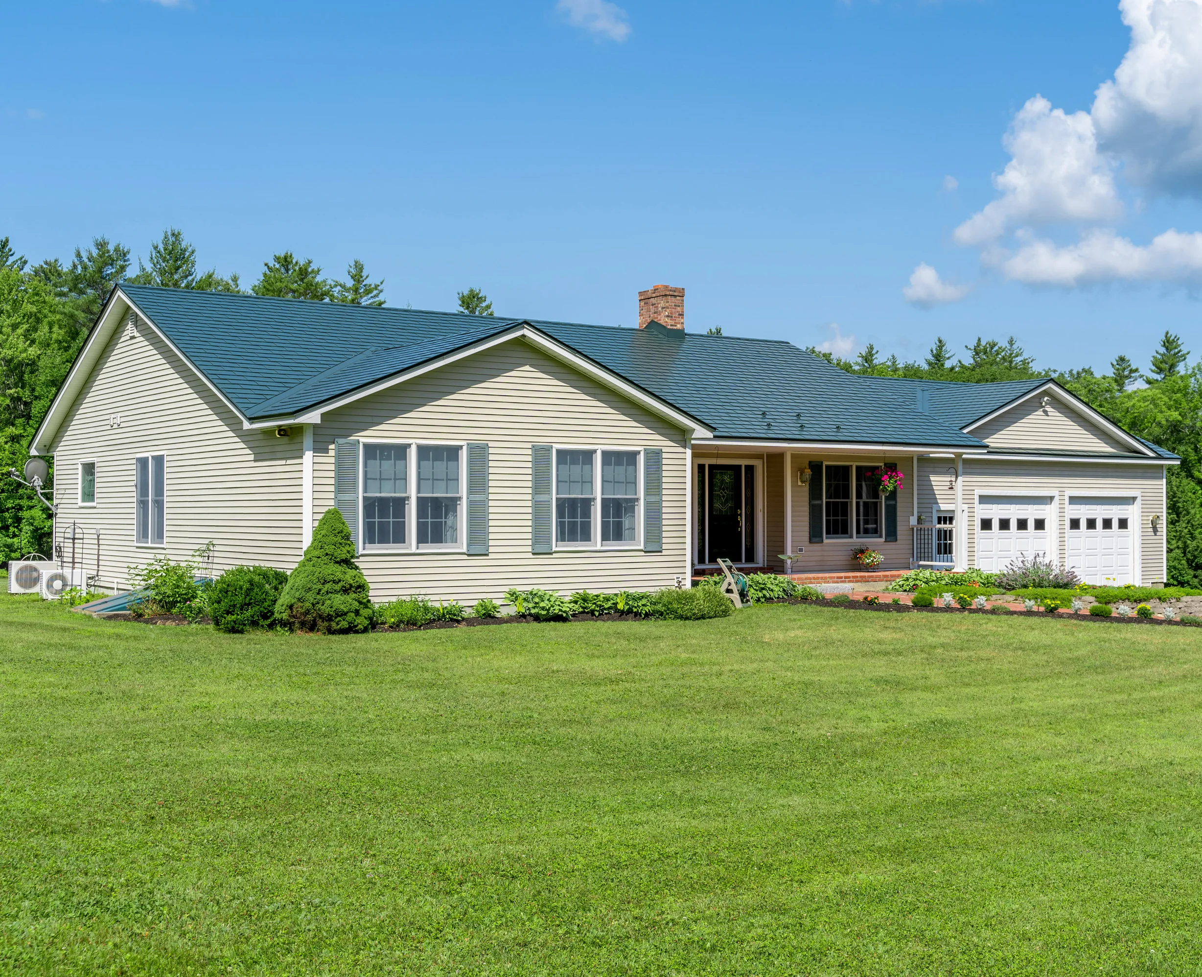 Hunter Green Interlock Slate aluminum roof on a cream-colored ranch-style home with a green metal roof, Sanbornville, New Hampshire