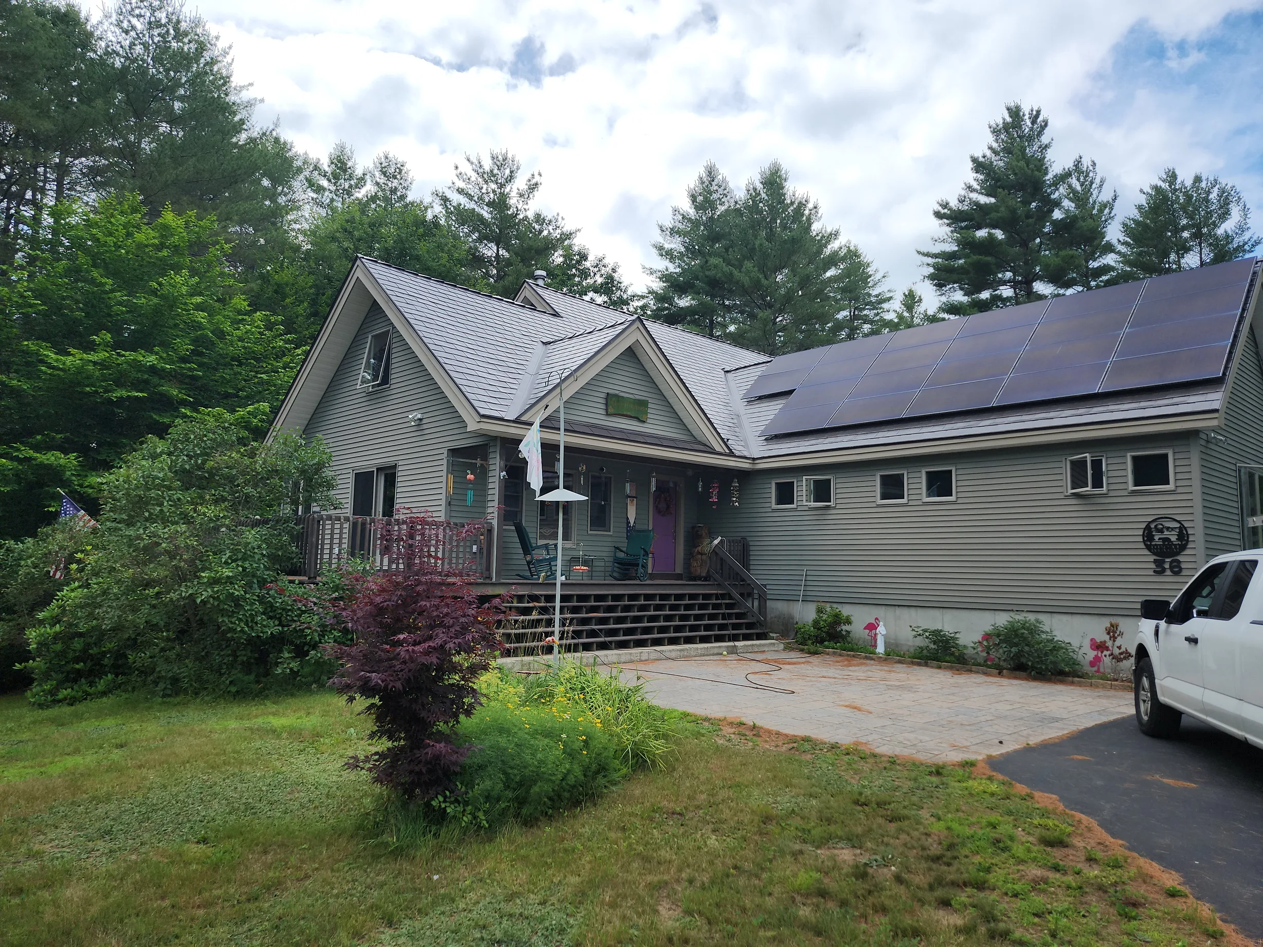 Tudor Brown Interlock Slate aluminum roof on a Tudor brown metal roof on a ranch style home among tall, Effingham, New Hampshire