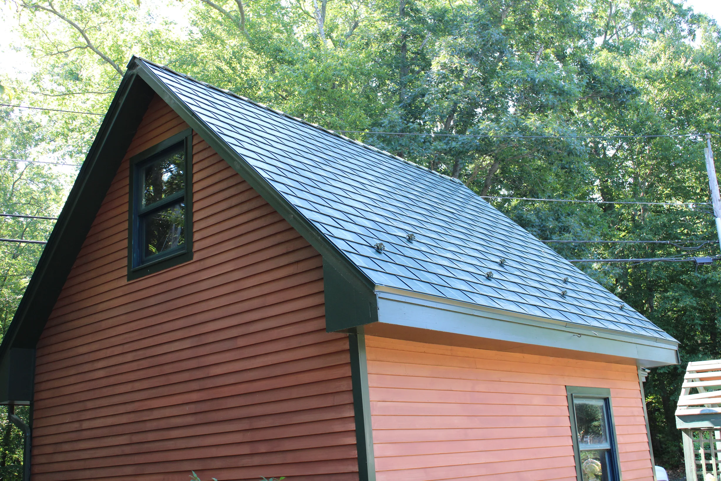 Hunter Green Interlock Slate aluminum roof being installed on the home, replacing an asphalt shingle roof being torn off, Pelham, New Hampshire