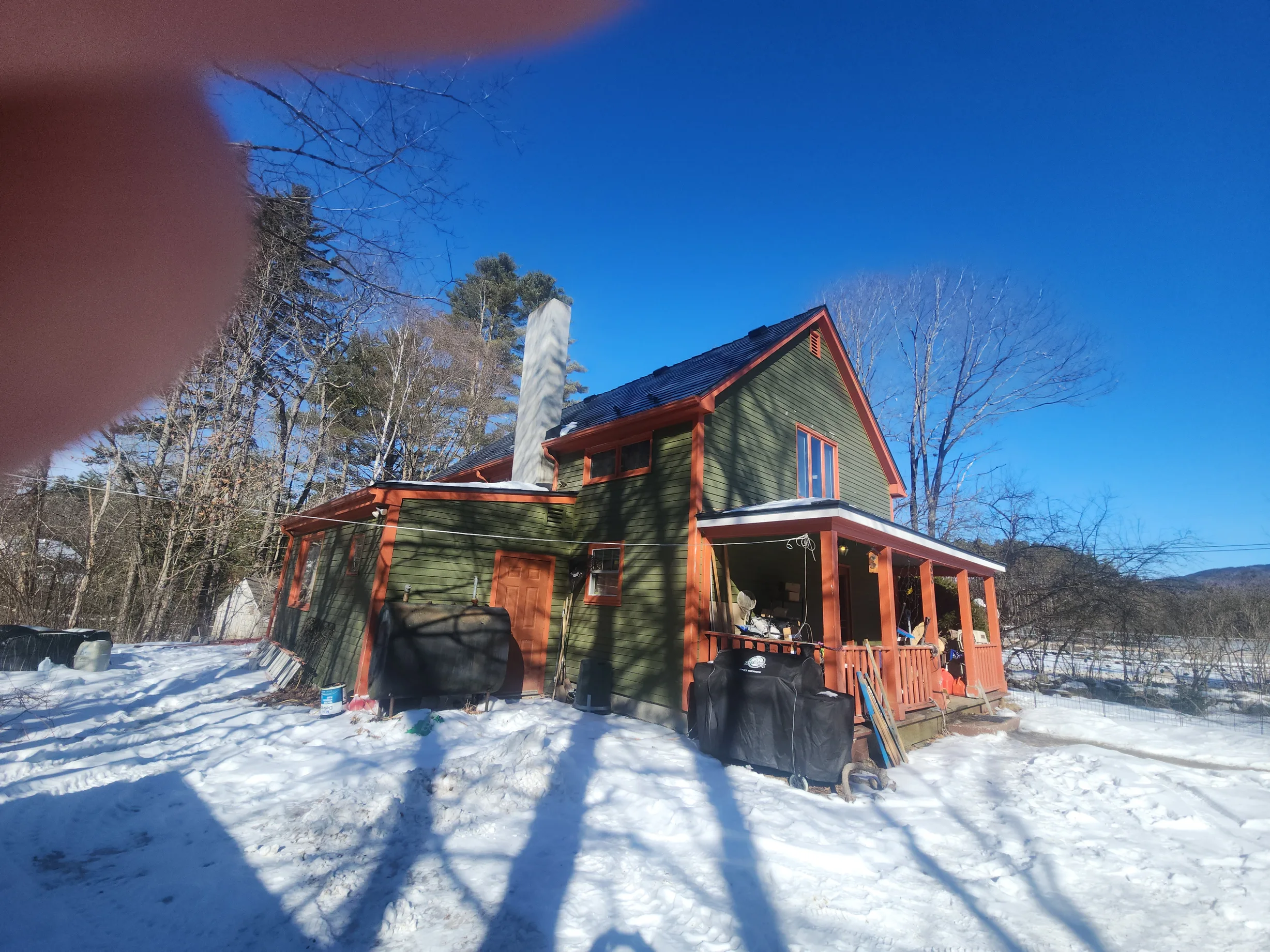 Deep Charcoal Interlock Slate aluminum roof on a two-storey home with a metal roof in Deep Charcoal among, Wilmot, New Hampshire