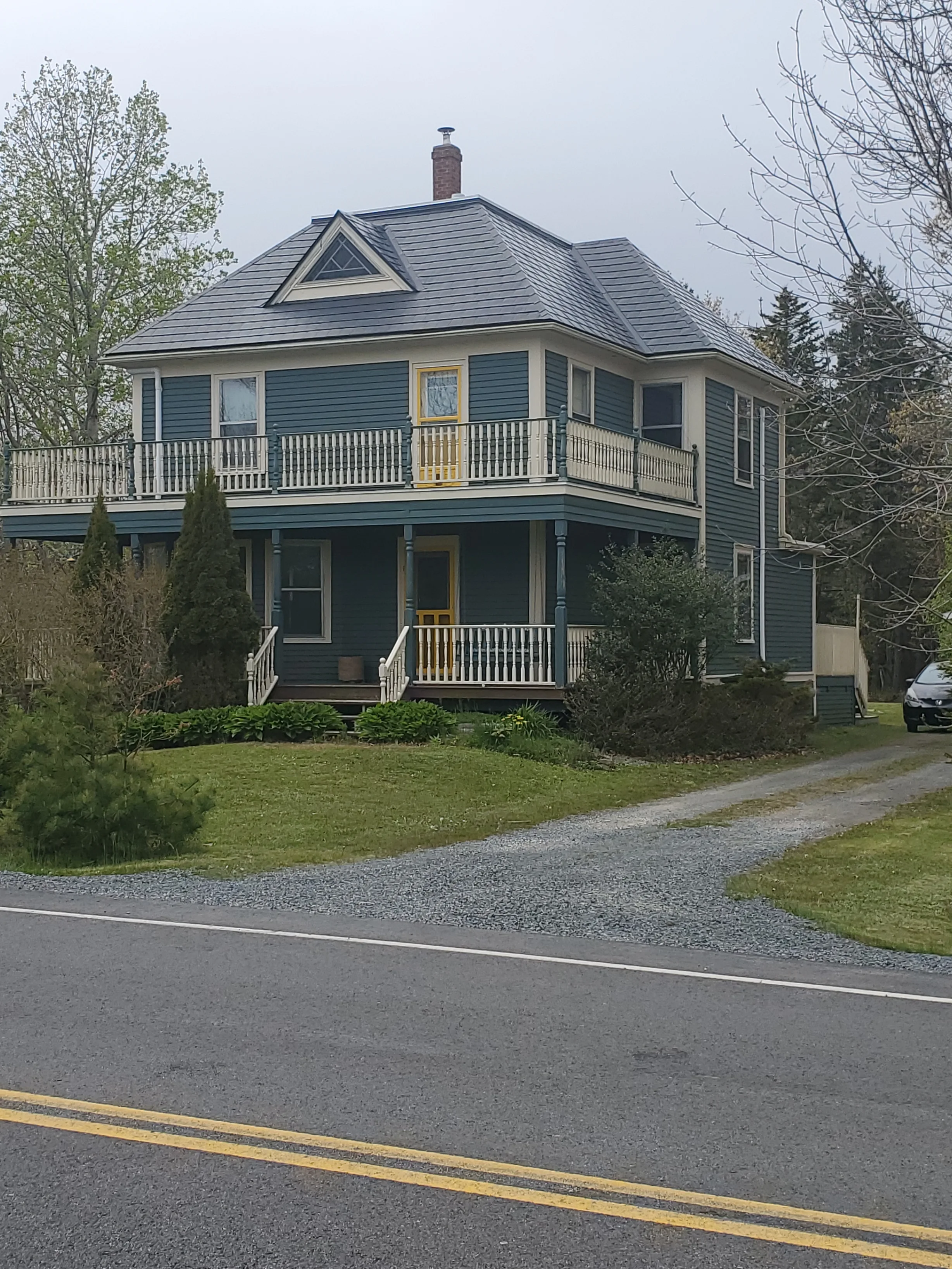 Black Interlock Slate aluminum roof on a two-storey Cape Cod home with dormers in a rural area, Riverport, Nova Scotia