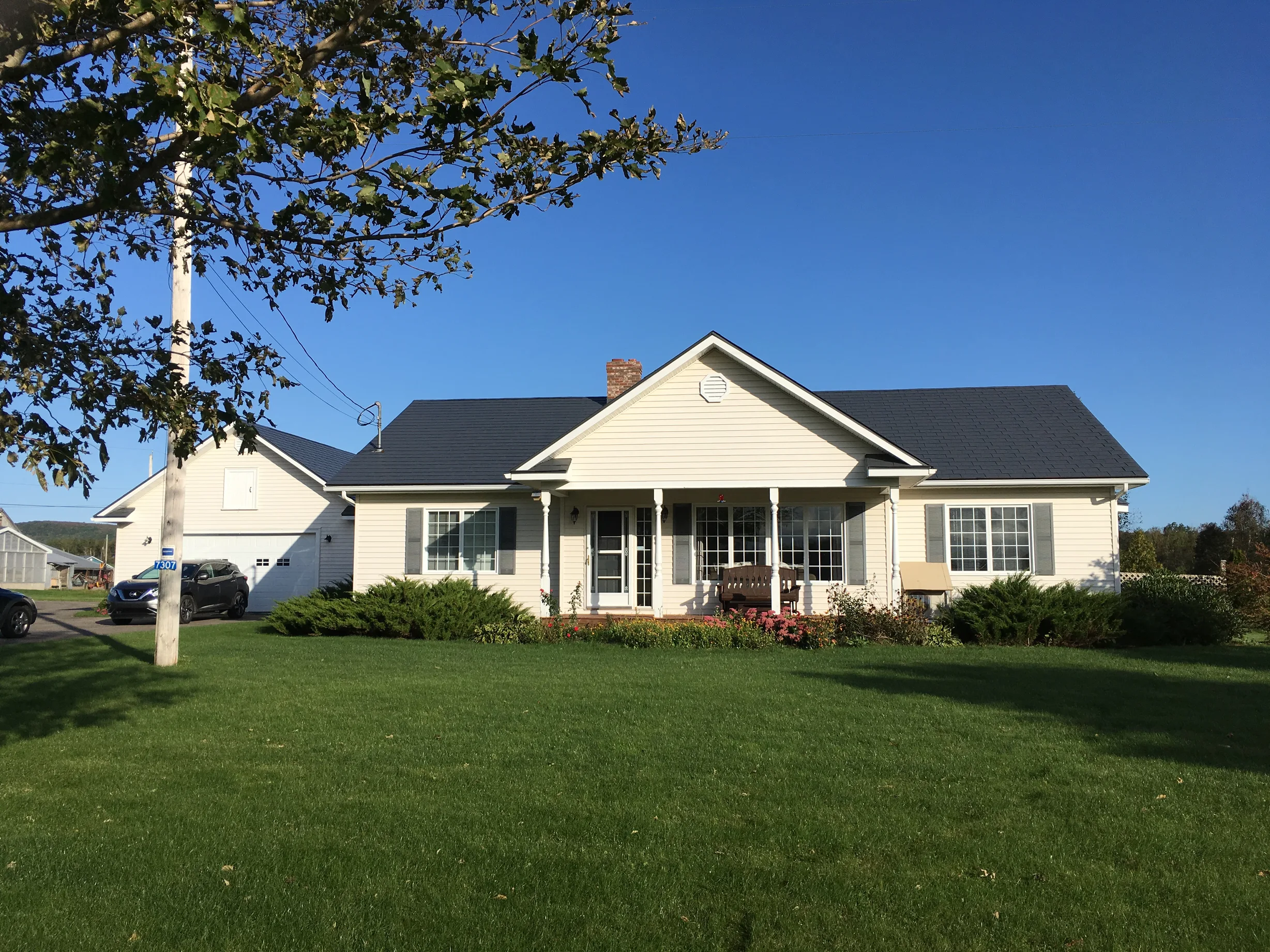 Charcoal Grey Interlock Slate aluminum roof on a white ranch home with a metal roof in a rural setting, Centreville, Nova Scotia