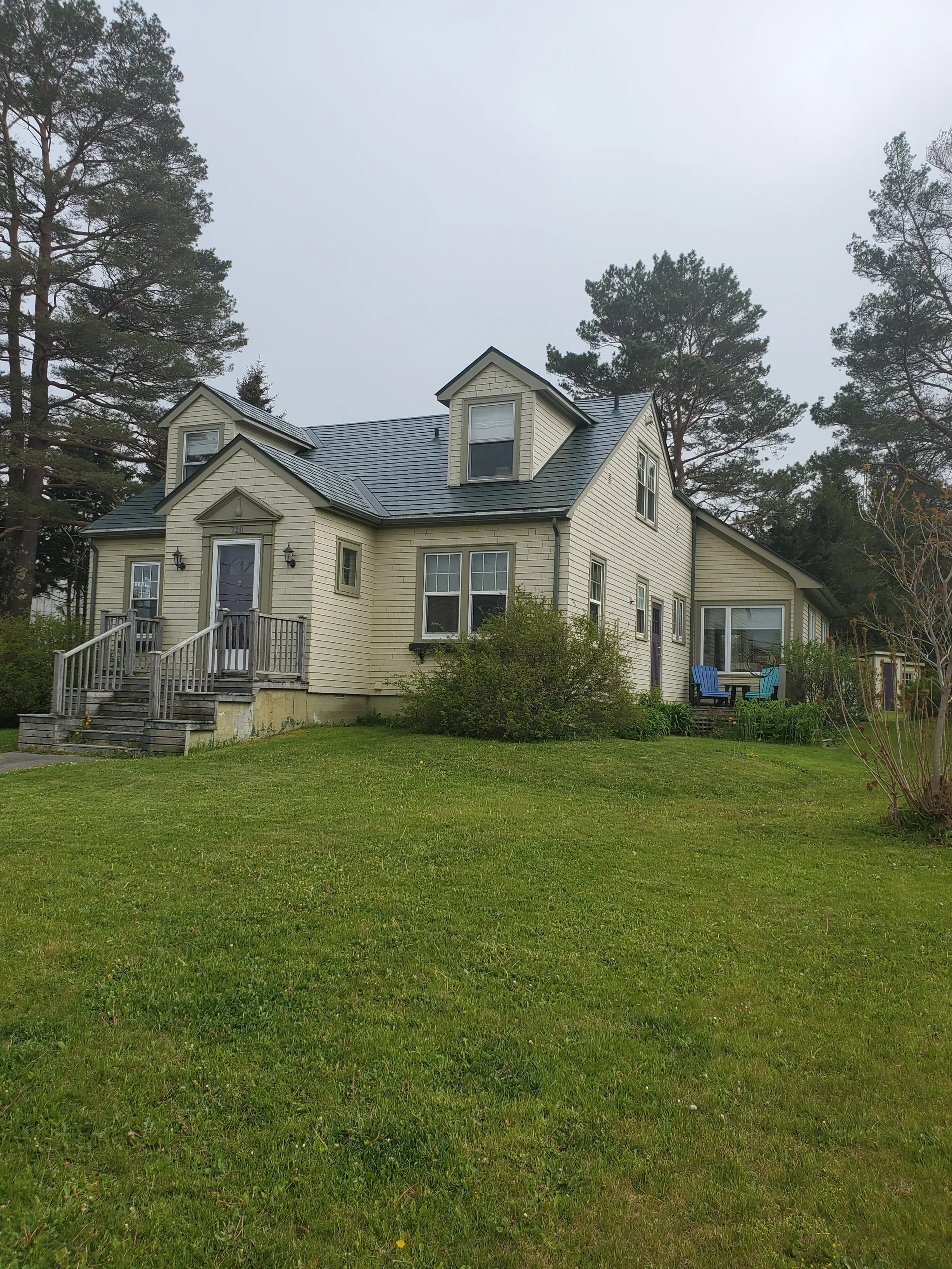Hunter Green Interlock Slate aluminum roof on a two-storey cape cod home with a hunter green metal roof, Mahone Bay, Nova Scotia