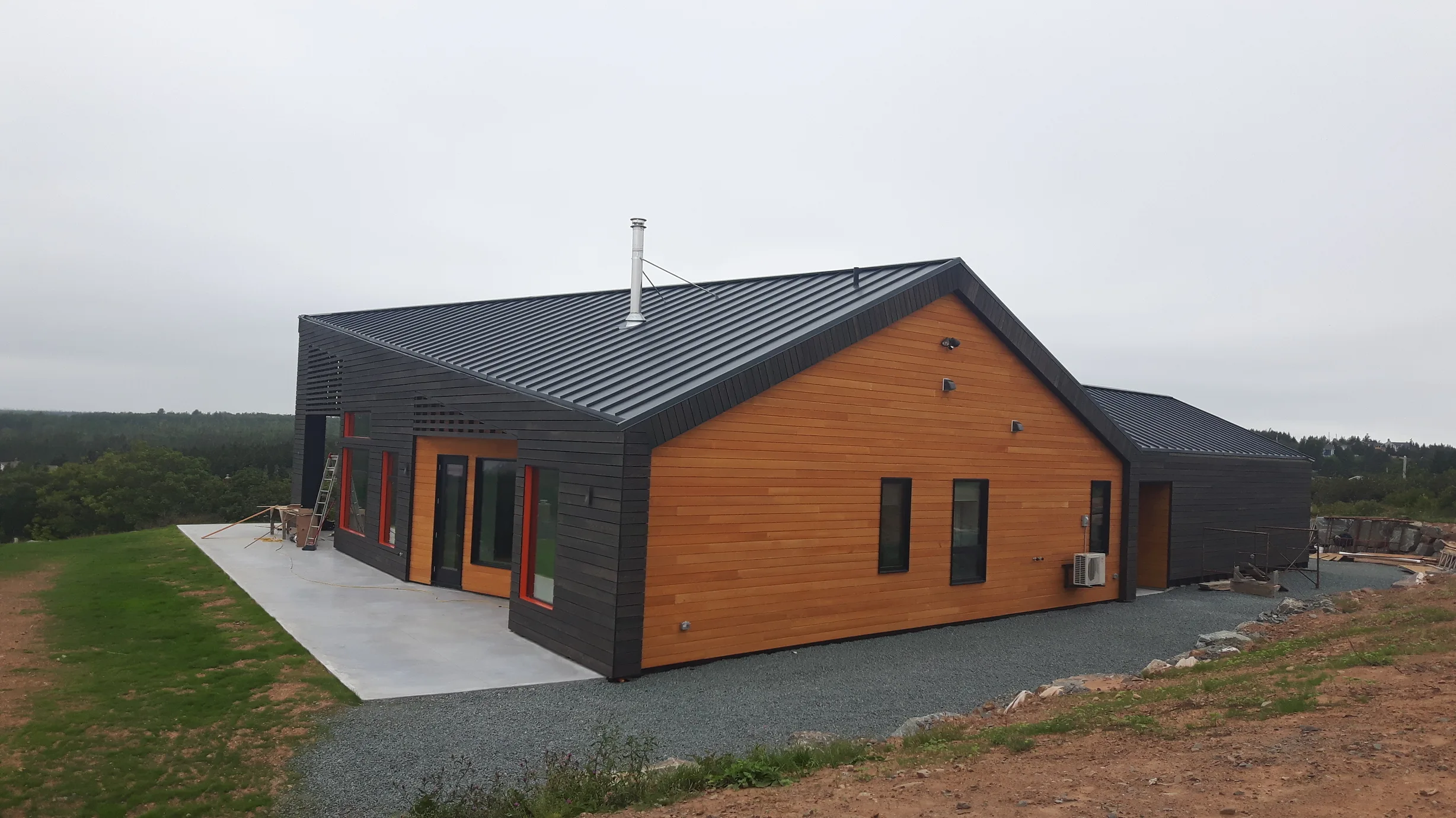 Deep Charcoal Interlock Standing Seam aluminum roof on a modern home with a black metal roof on a coastal rural, Cow Bay, Nova Scotia