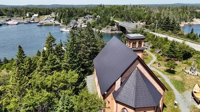 Black Interlock Slate aluminum roof being installed on the home, Lahave, Nova Scotia