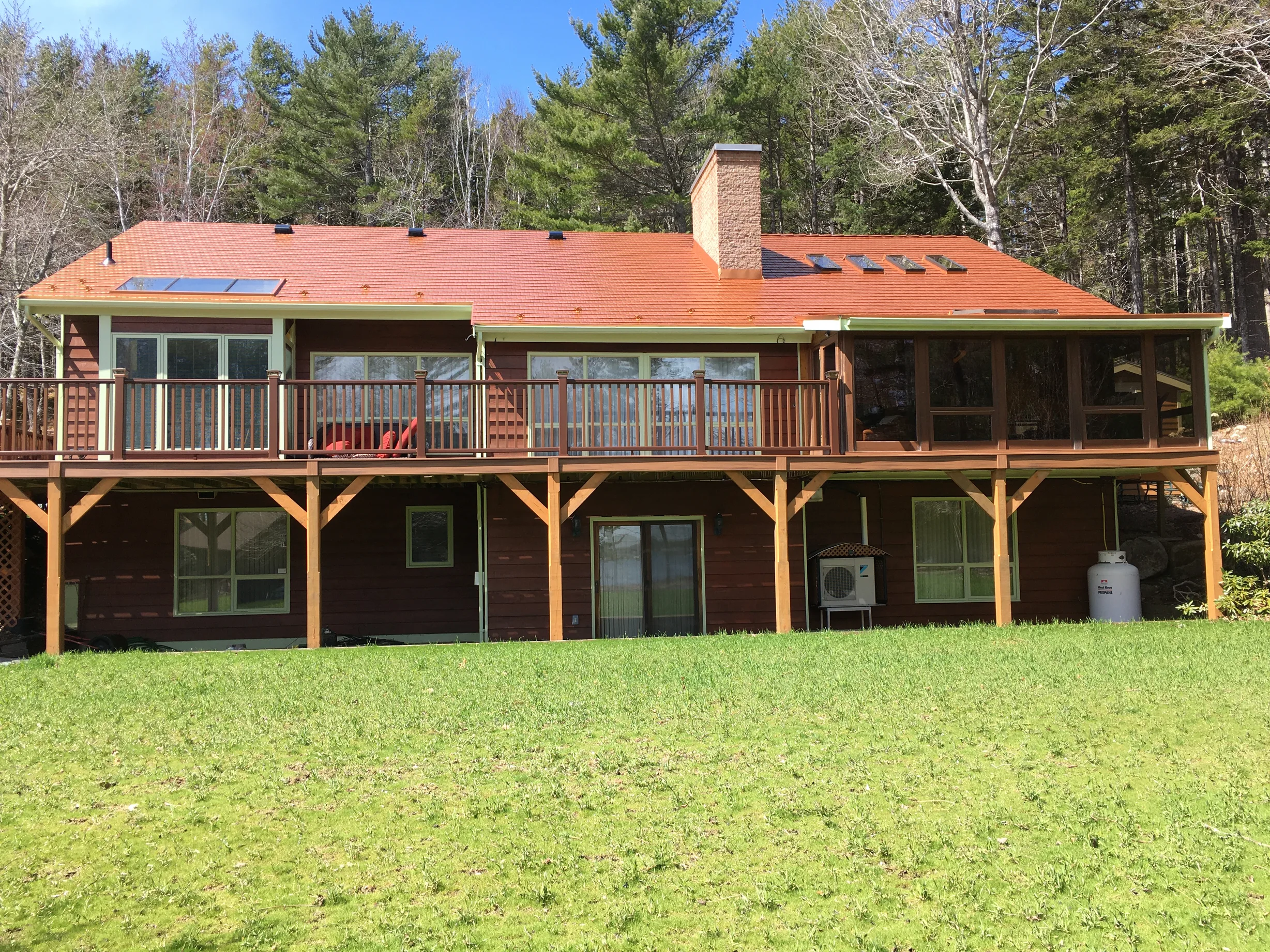 Copper Penny Interlock Cedar Shingle aluminum roof on the home with chimney, Pentz, Nova Scotia