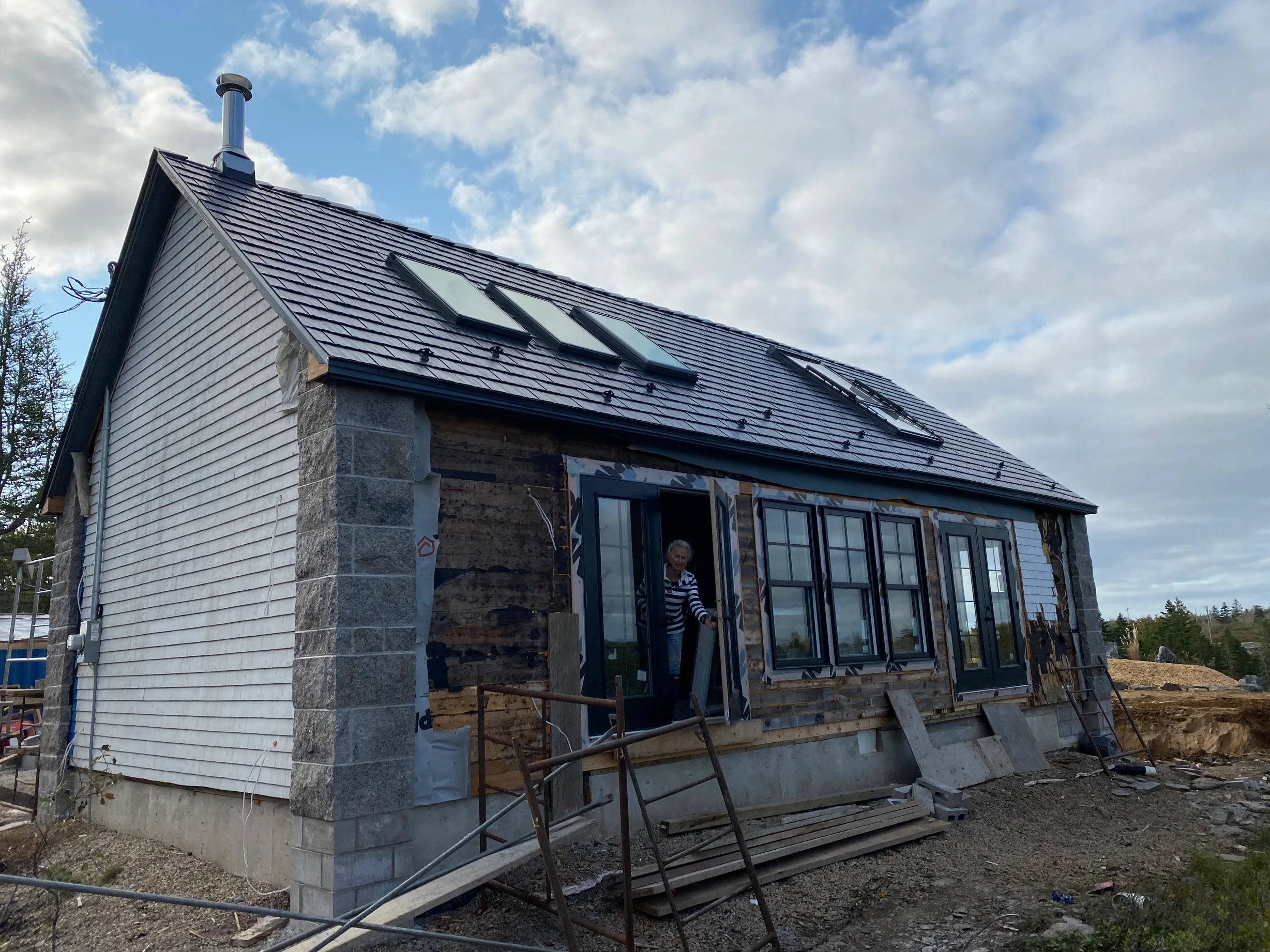 Deep Charcoal Interlock Cedar Shingle aluminum roof being installed on the home, Lunenburg, Nova Scotia