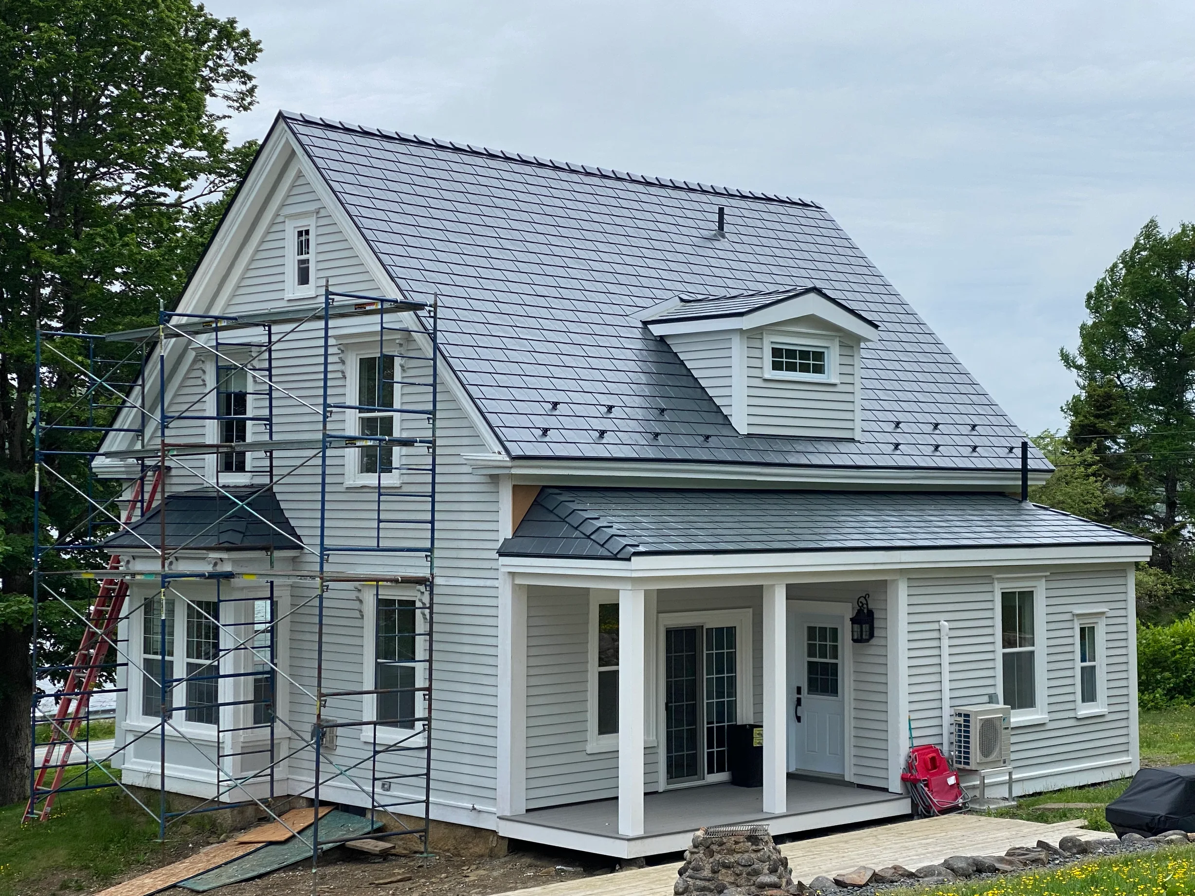 Deep Charcoal Interlock Slate aluminum roof being installed on the home, East LaHave, Nova Scotia