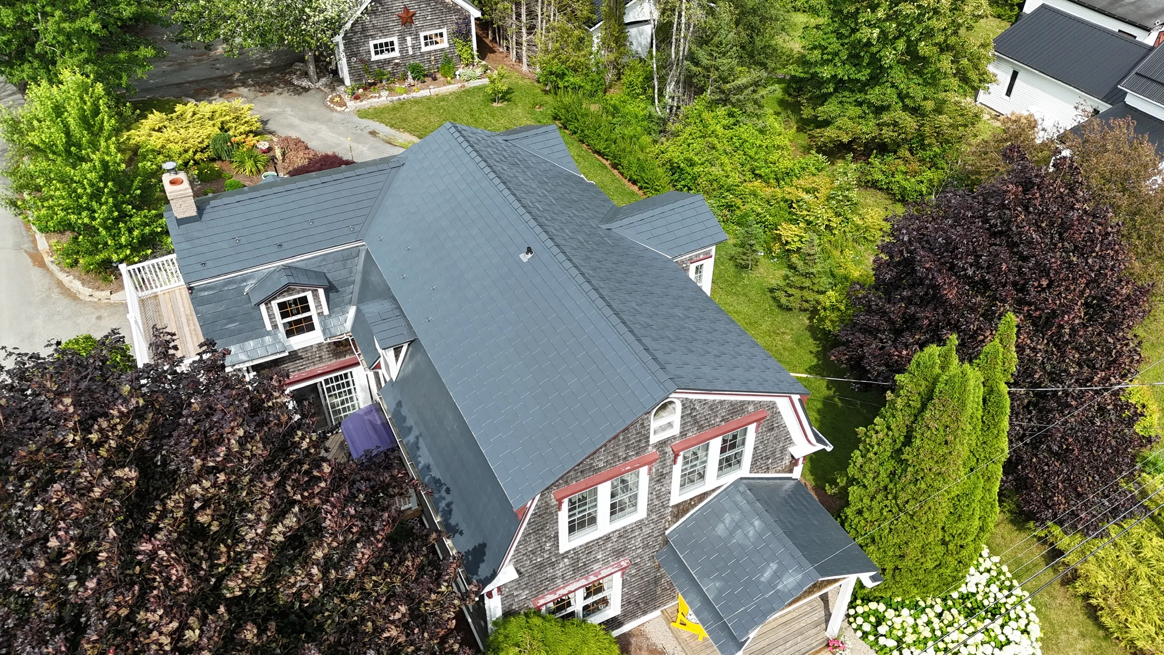 Deep Charcoal Interlock Slate aluminum roof on the home with ridge cap and ridge vent, East LaHave, Nova Scotia