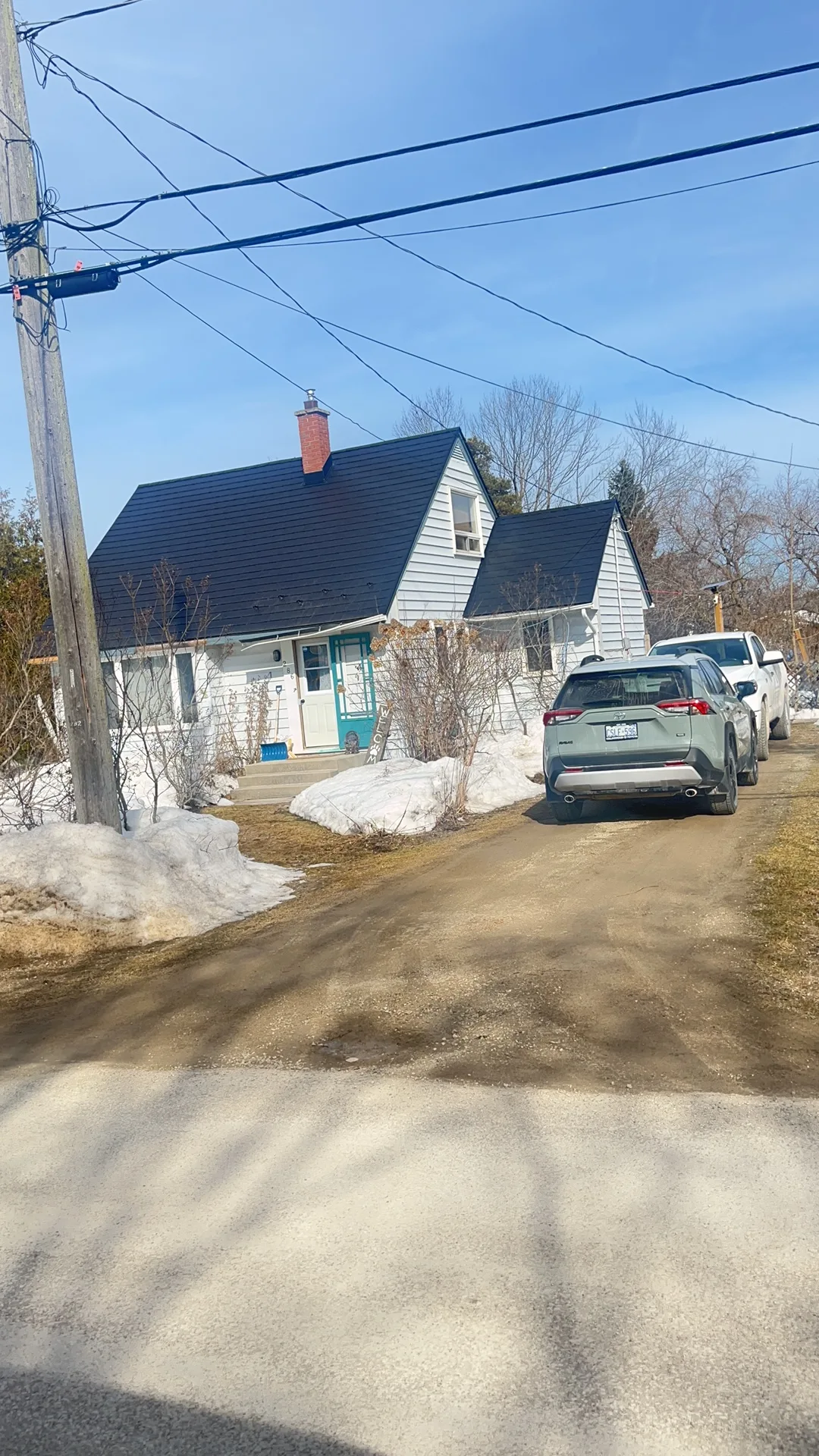 Black Interlock Slate aluminum roof being installed on the home, replacing a worn out asphalt shingle roof, Meaford, Ontario