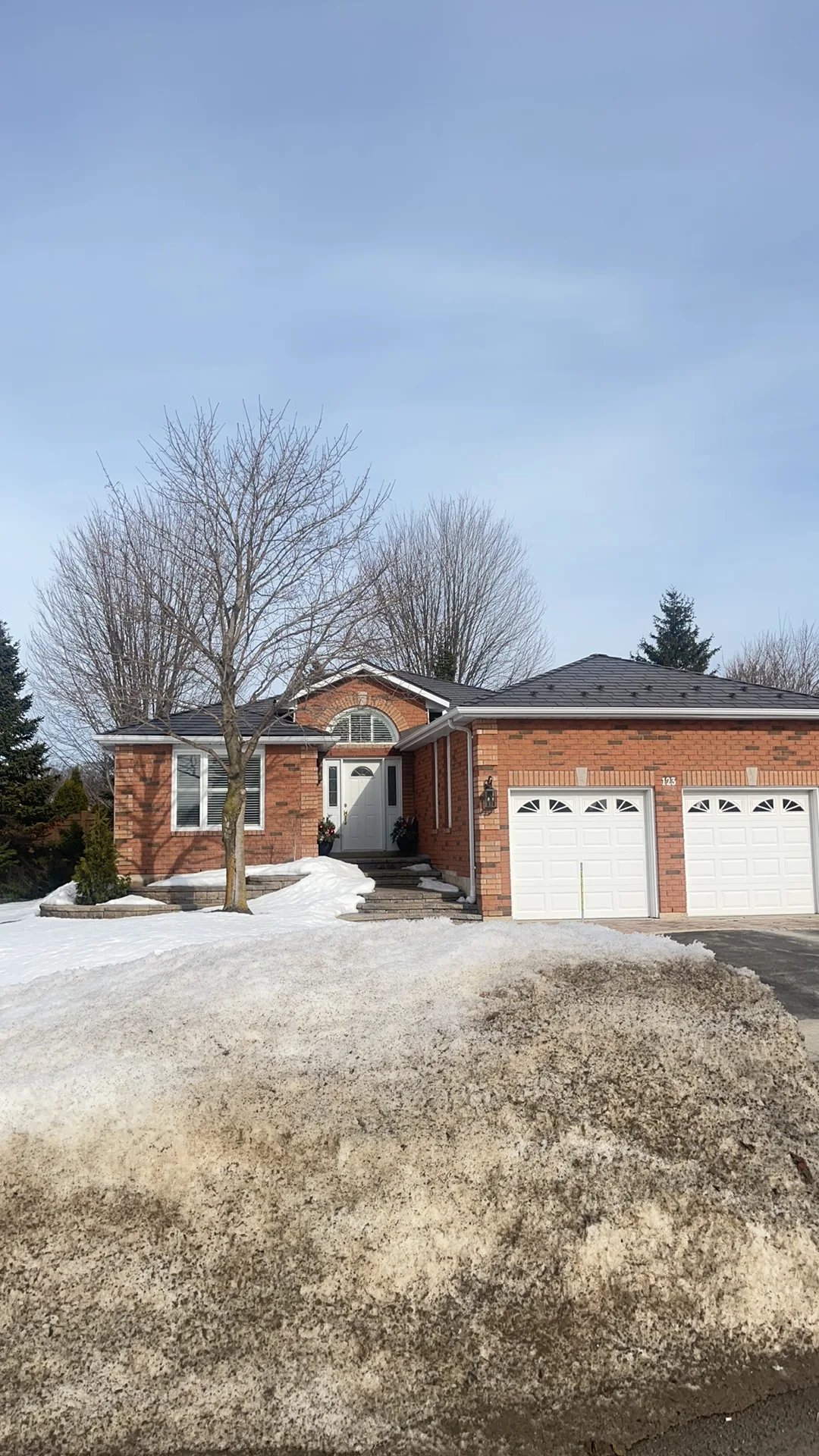 Tudor Brown Interlock Slate aluminum roof on a brown brick home with a metal roof in a suburban, Barrie, Ontario