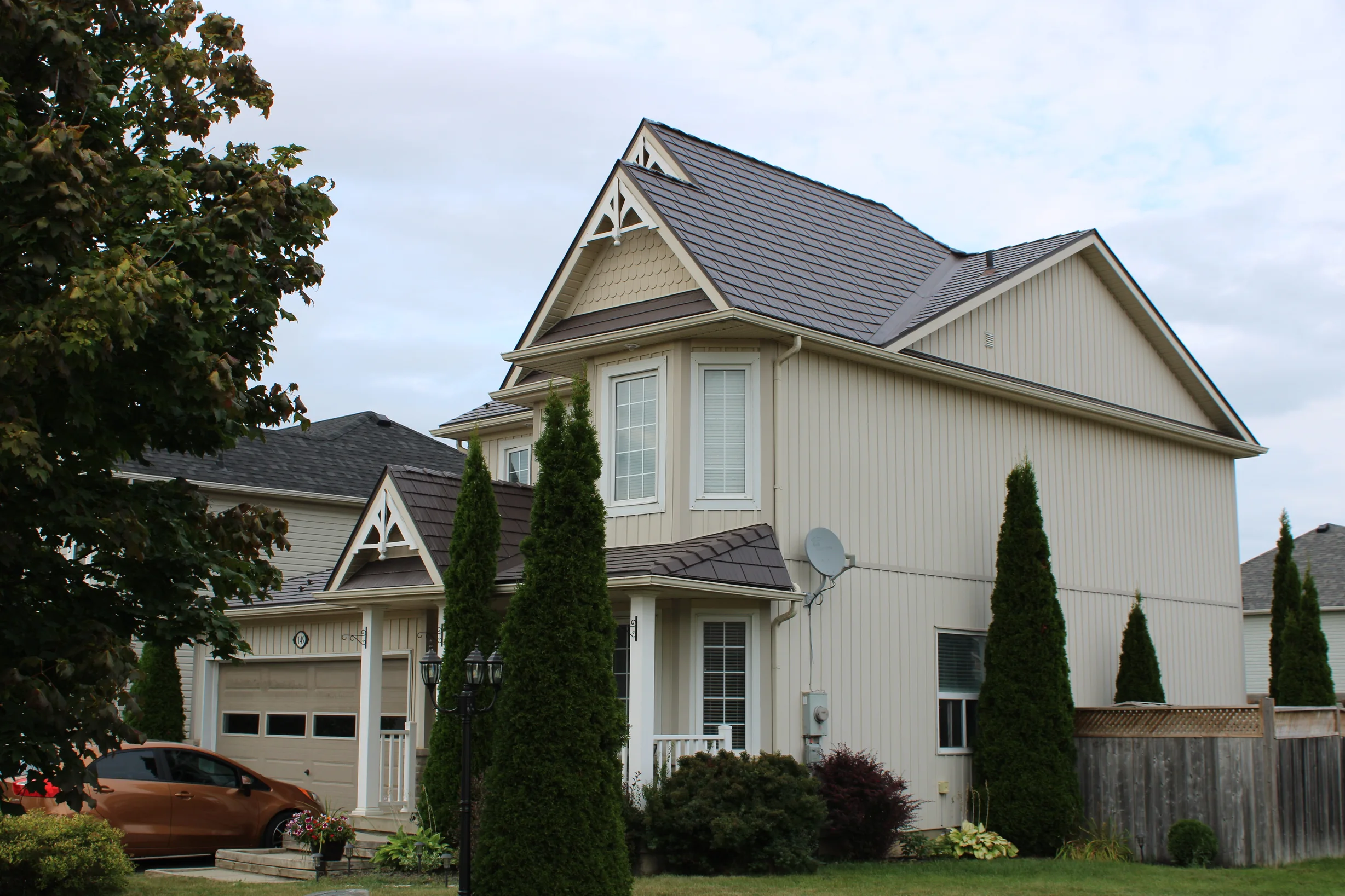 Tudor Brown Interlock Cedar Shingle aluminum roof on a Tudor-style home with a Tudor Brown metal roof in a, Shelburne, Ontario
