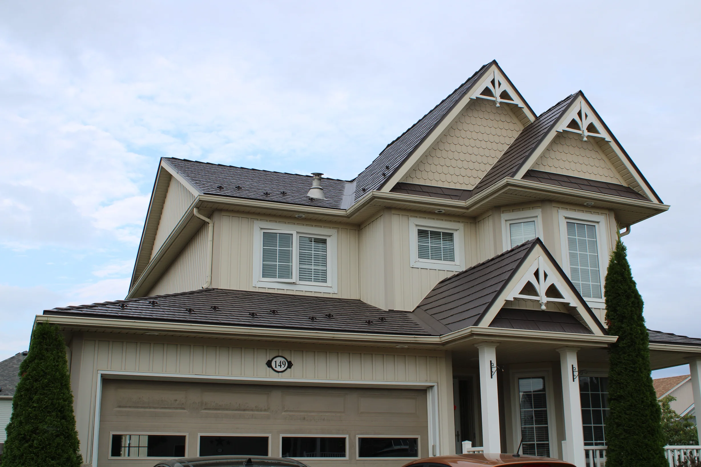 Tudor Brown Interlock Cedar Shingle aluminum roof on a Tudor-style home with a Tudor Brown metal roof in, Shelburne, Ontario