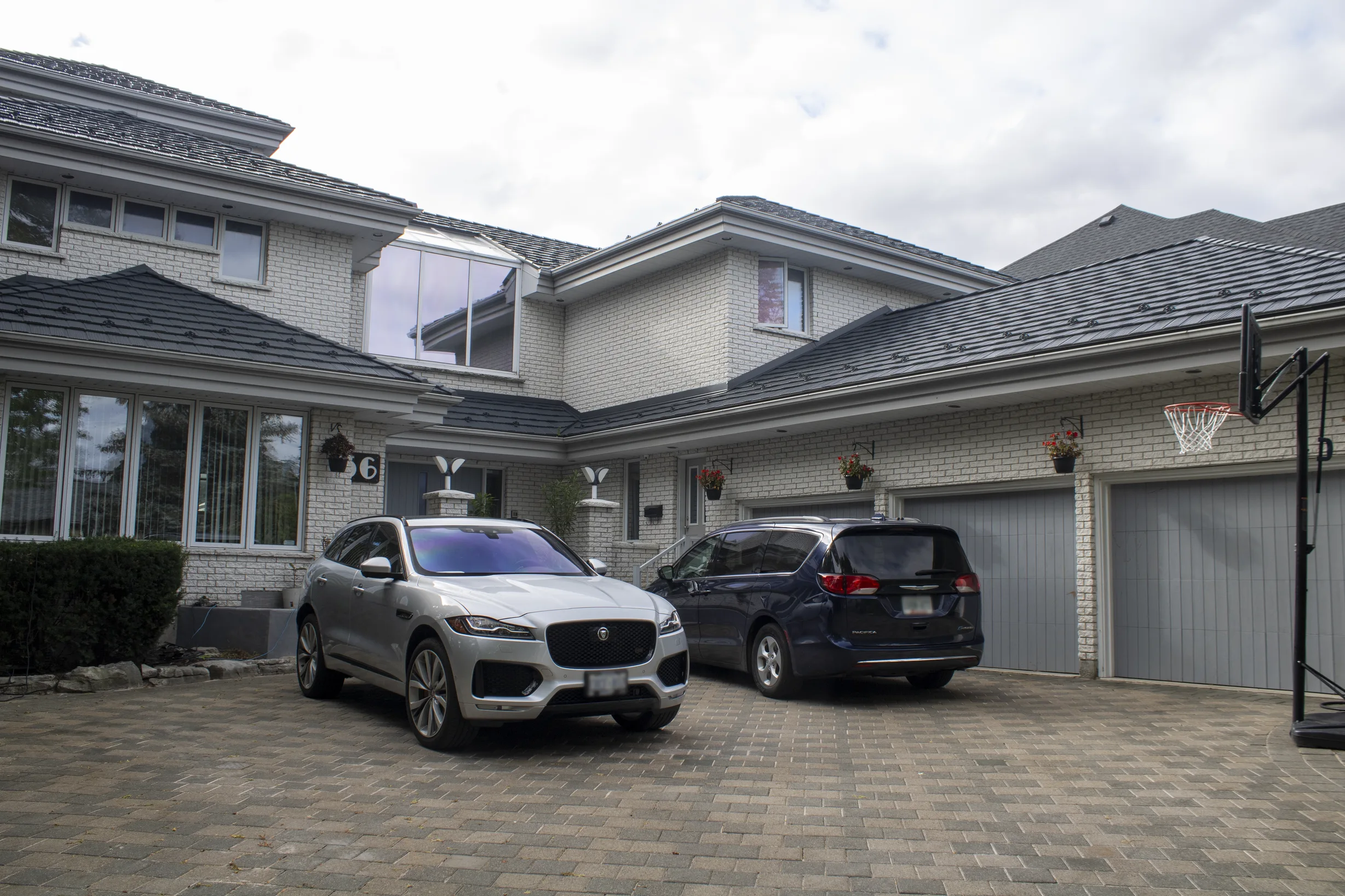 Charcoal Grey Interlock Shake aluminum roof on a white brick house with a garage and a driveway, Whitby, Ontario