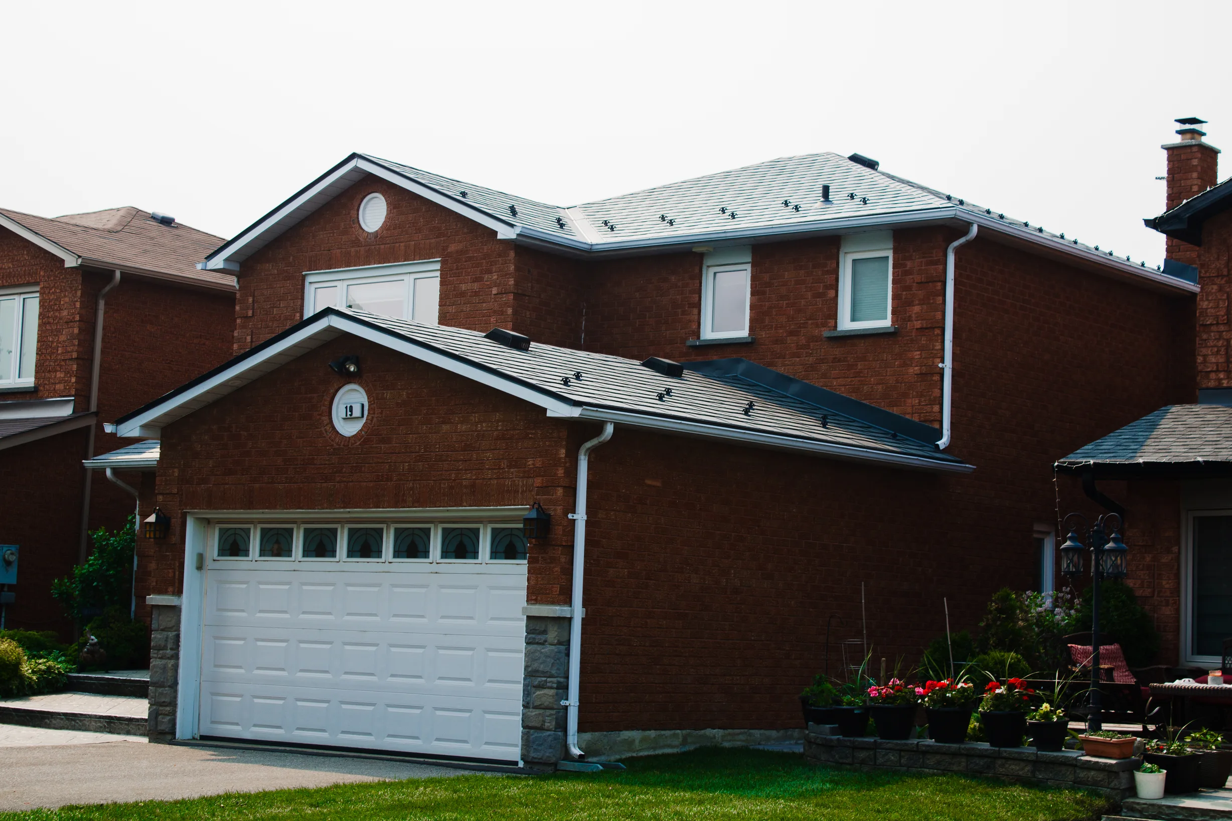 Deep Charcoal Interlock Slate aluminum roof on a Deep Charcoal Interlock Slate metal roof on a brick, Maple, Ontario