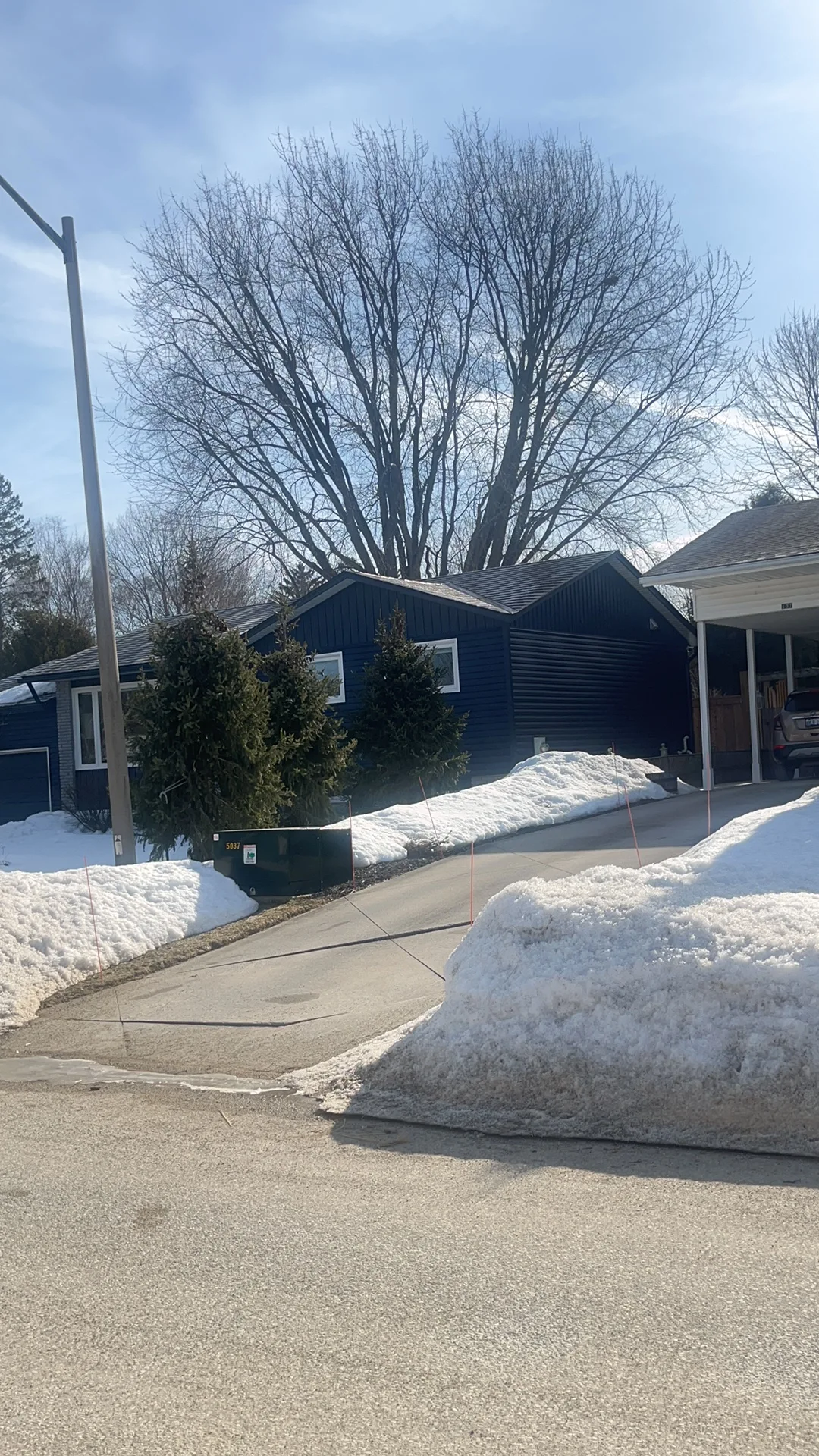 Tudor Brown Interlock Slate aluminum roof on a brown home with dormers in a snowy suburban setting, Thornbury, Ontario