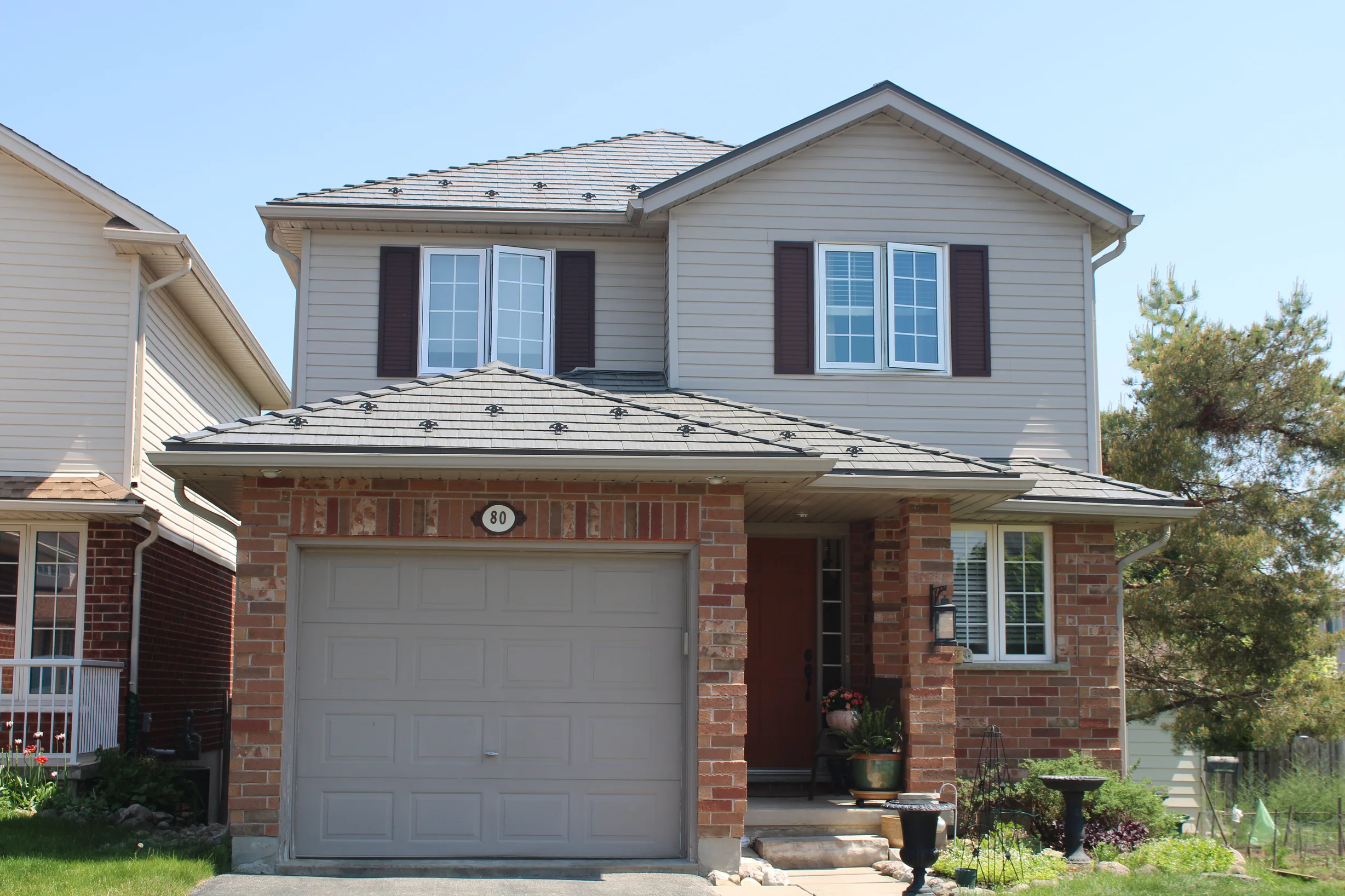 Musket Grey Interlock Cedar Shingle aluminum roof on a two-storey home with a metal roof in a suburban, Guelph, Ontario
