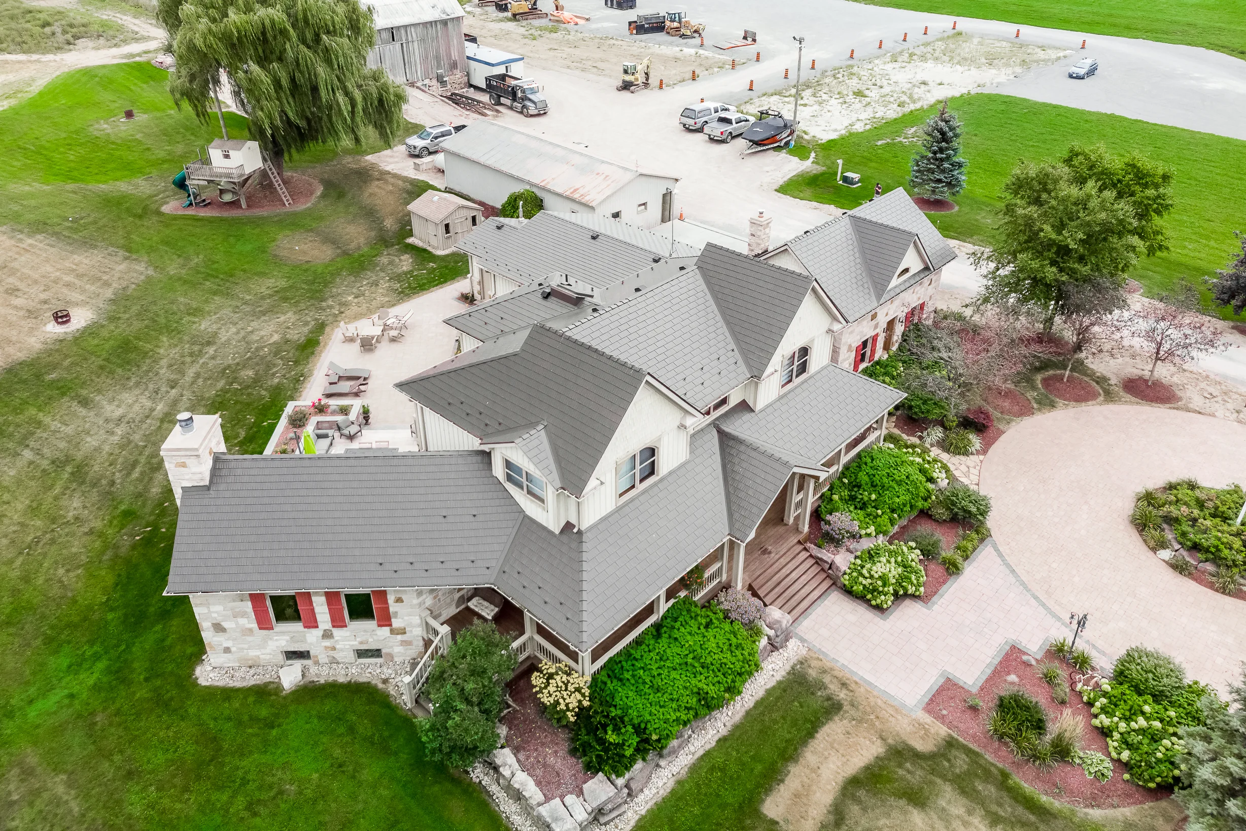 Tudor Brown Interlock Cedar Shingle aluminum roof on a Tudor style home in Tudor Brown metal roofing with lush, Pefferlaw, Ontario
