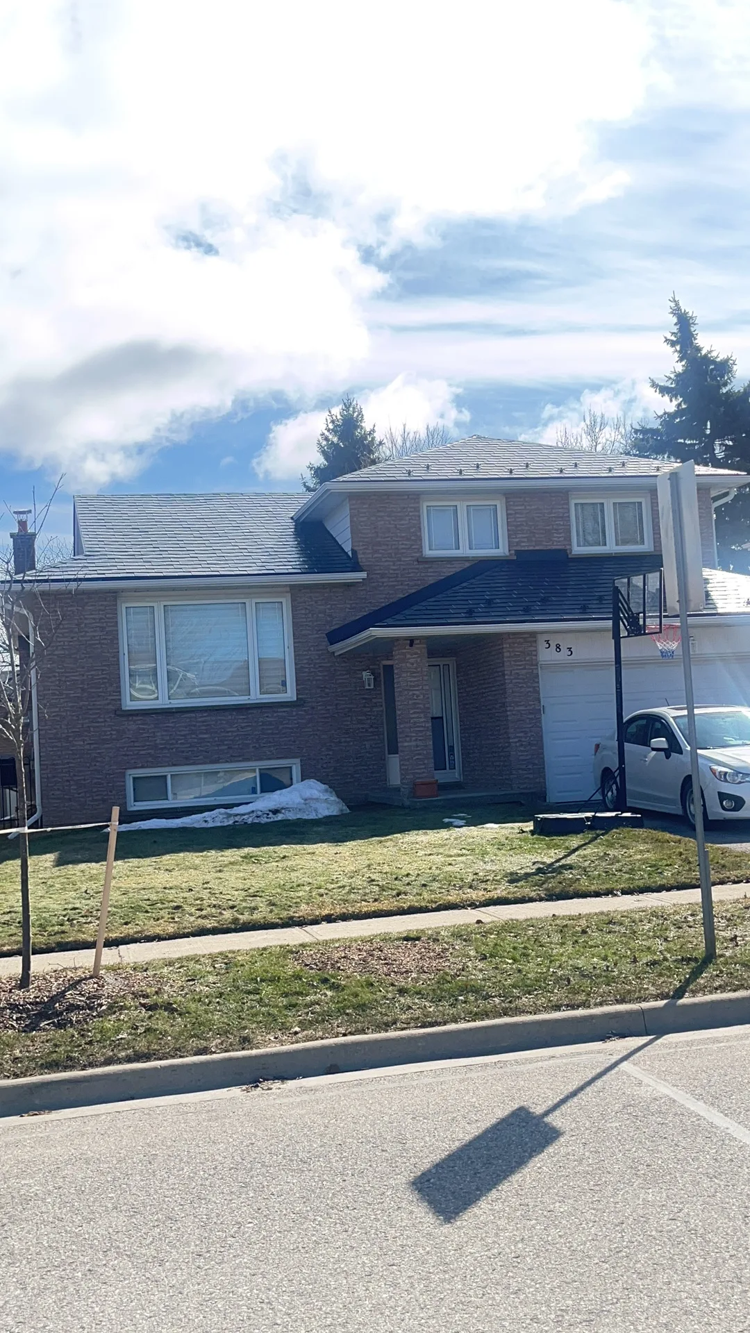 Deep Charcoal Interlock Slate aluminum roof on a two-storey home with brick exterior in a suburban, Bradford, Ontario