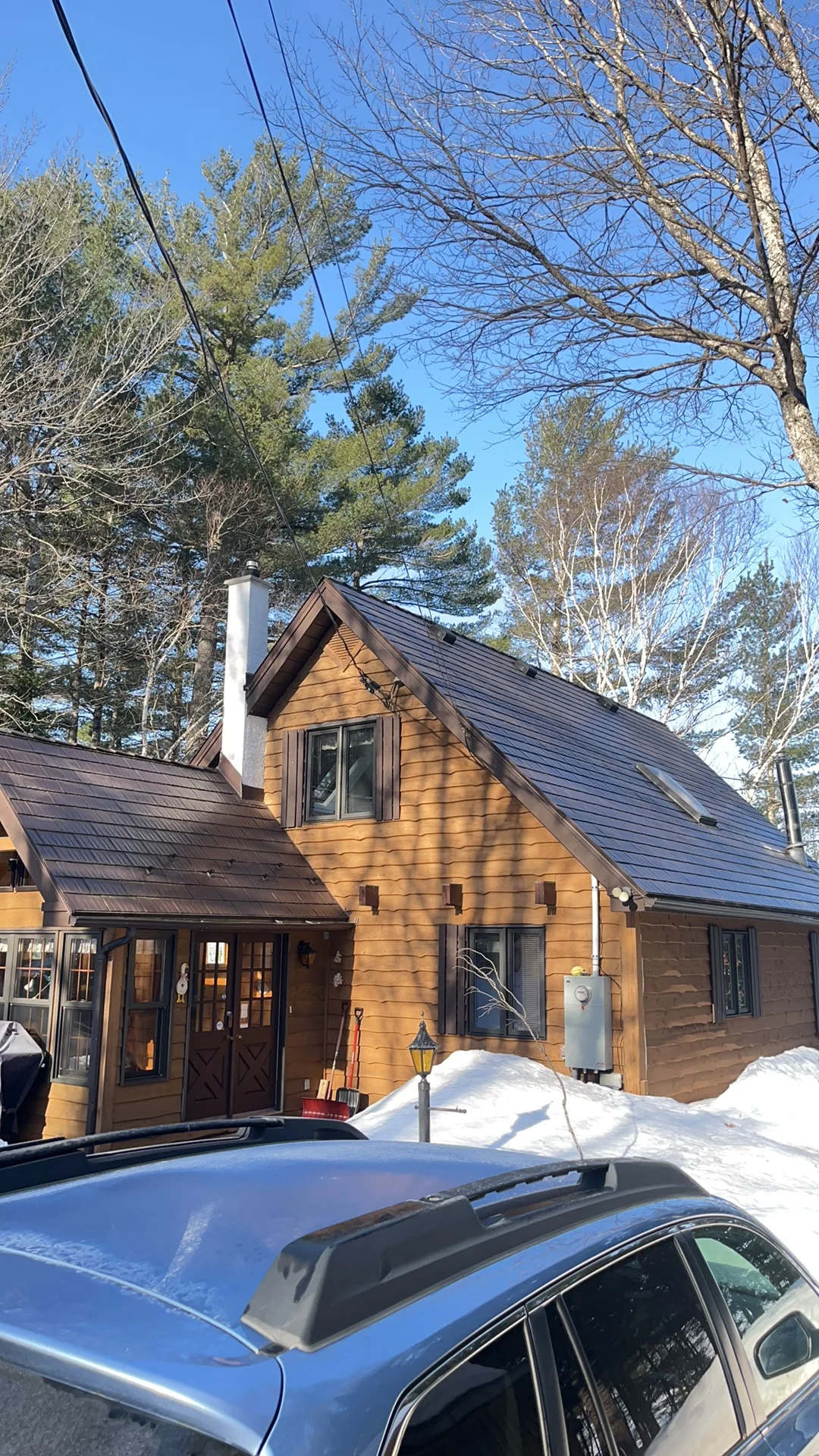 Colonial Brown Interlock Cedar Shingle aluminum roof on a Colonial Brown metal roof on a chalet in a forested, Algonquin Highlands, Ontario