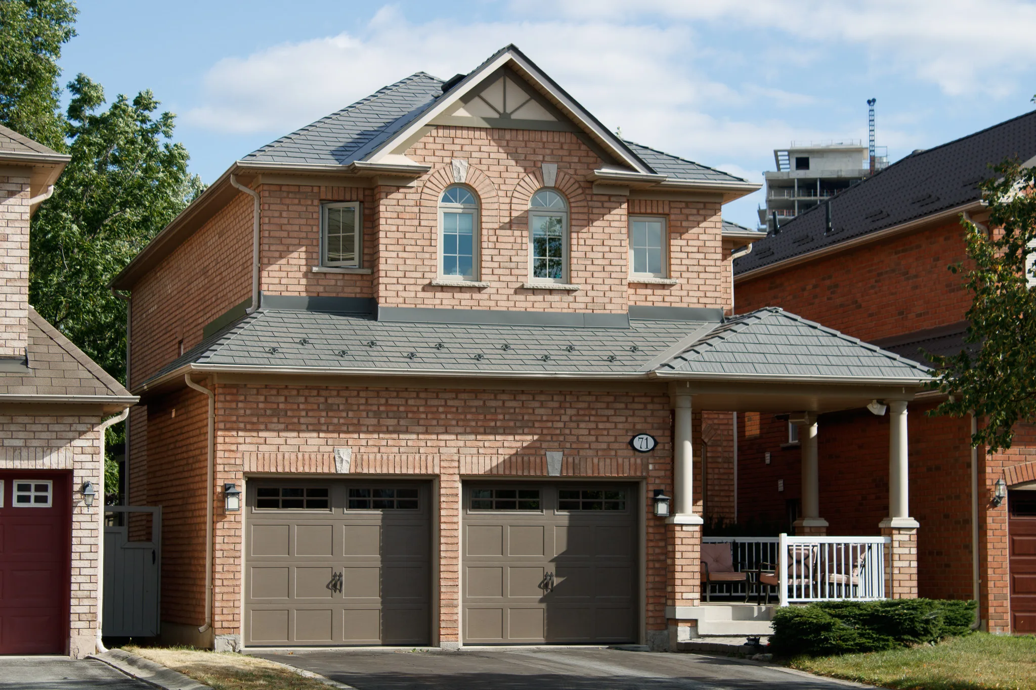 Black Interlock Cedar Shingle aluminum roof on a brick two-storey home with dormers in a suburban, Toronto, Ontario