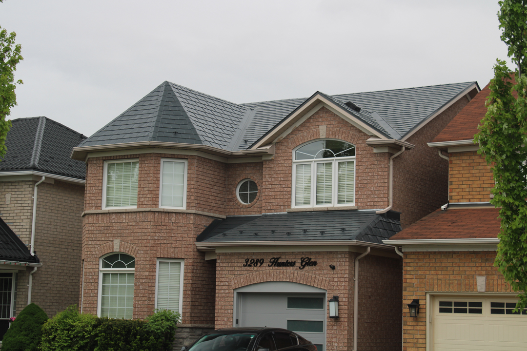 Two-storey brick home at 3289 Hunters Glen, Mississauga, with deep charcoal Interlock aluminum slate metal roofing featuring a turreted bay, multiple hips, and valleys.
