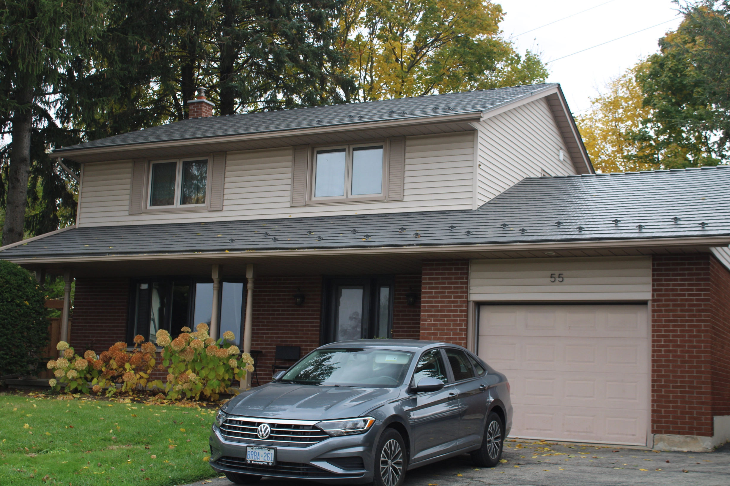 Musket Grey Interlock Cedar Shingle aluminum roof on a modern home with a metal roof in a forested area, Kitchener, Ontario
