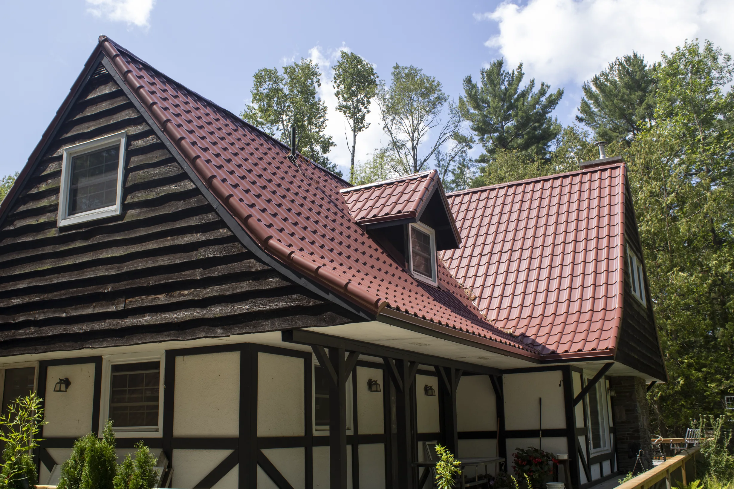 Tile Red Interlock Tile aluminum roof on a red metal roof on a cottage in the forest by the lake, Gravenhurst, Ontario
