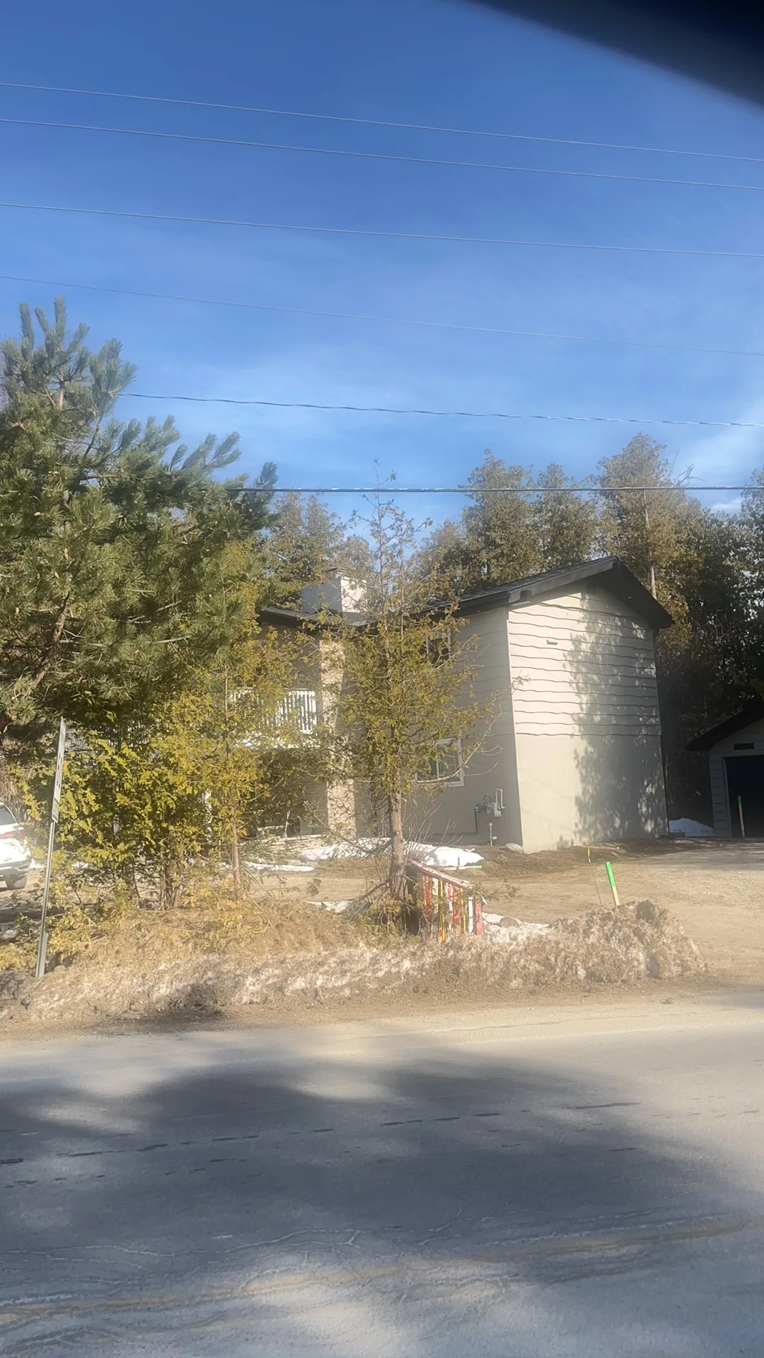 Black Interlock Slate aluminum roof being installed on a single-family home with a metal roof among trees in the, The Blue Mountain, Ontario