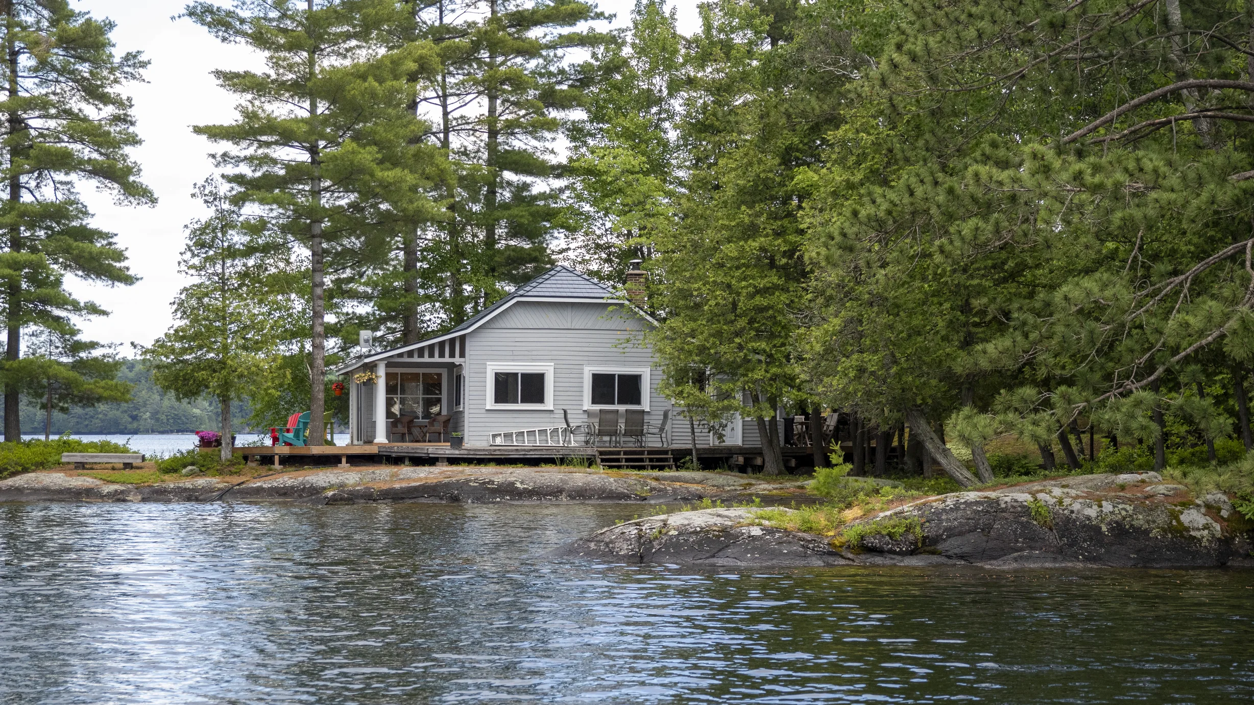 Deep Charcoal Interlock Cedar Shingle aluminum roof on a white home with a metal roof on a waterfront property, Winderemere, Ontario