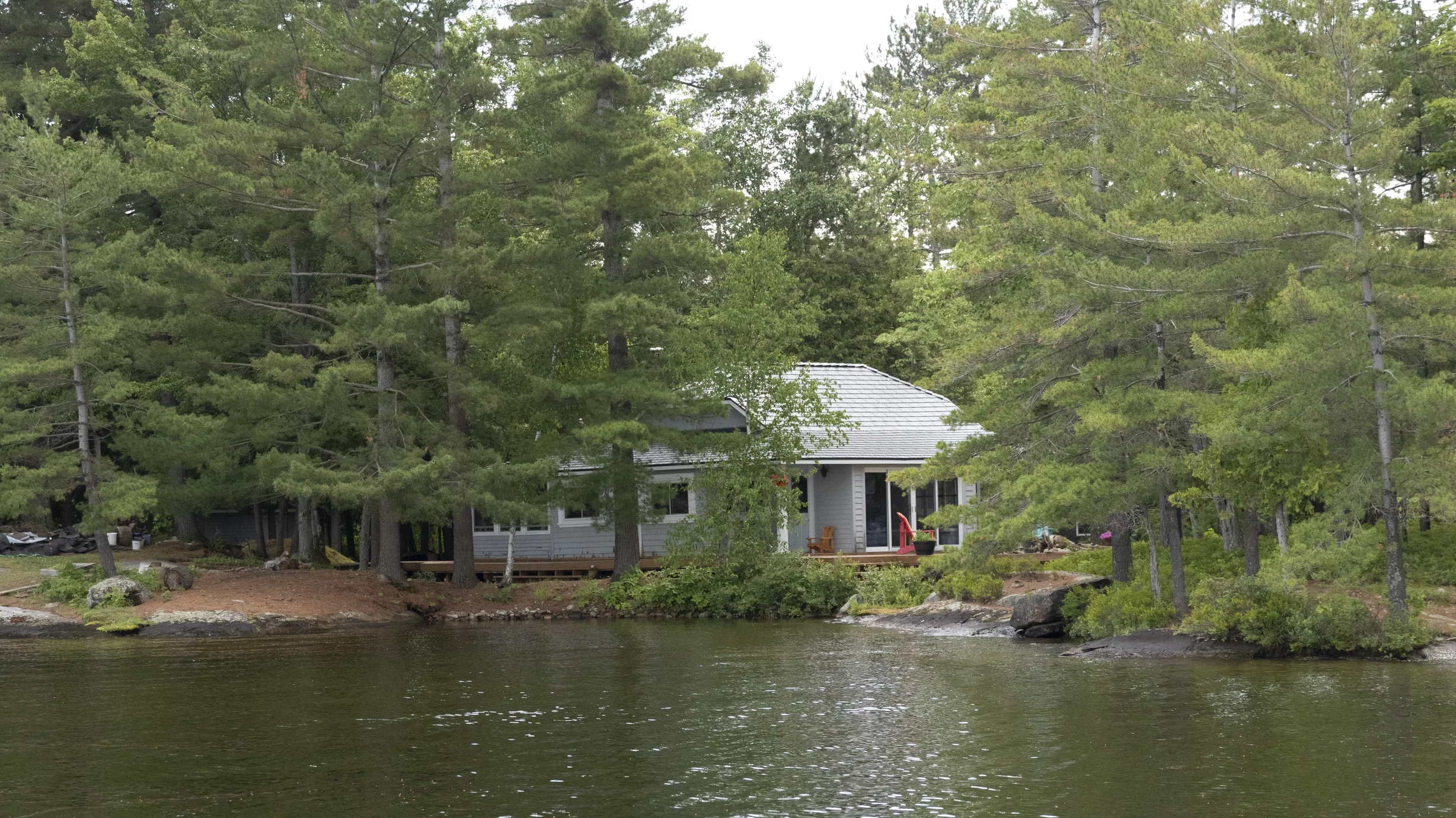 Deep Charcoal Interlock Cedar Shingle aluminum roof on a small house with a metal roof among trees on a lake, Winderemere, Ontario